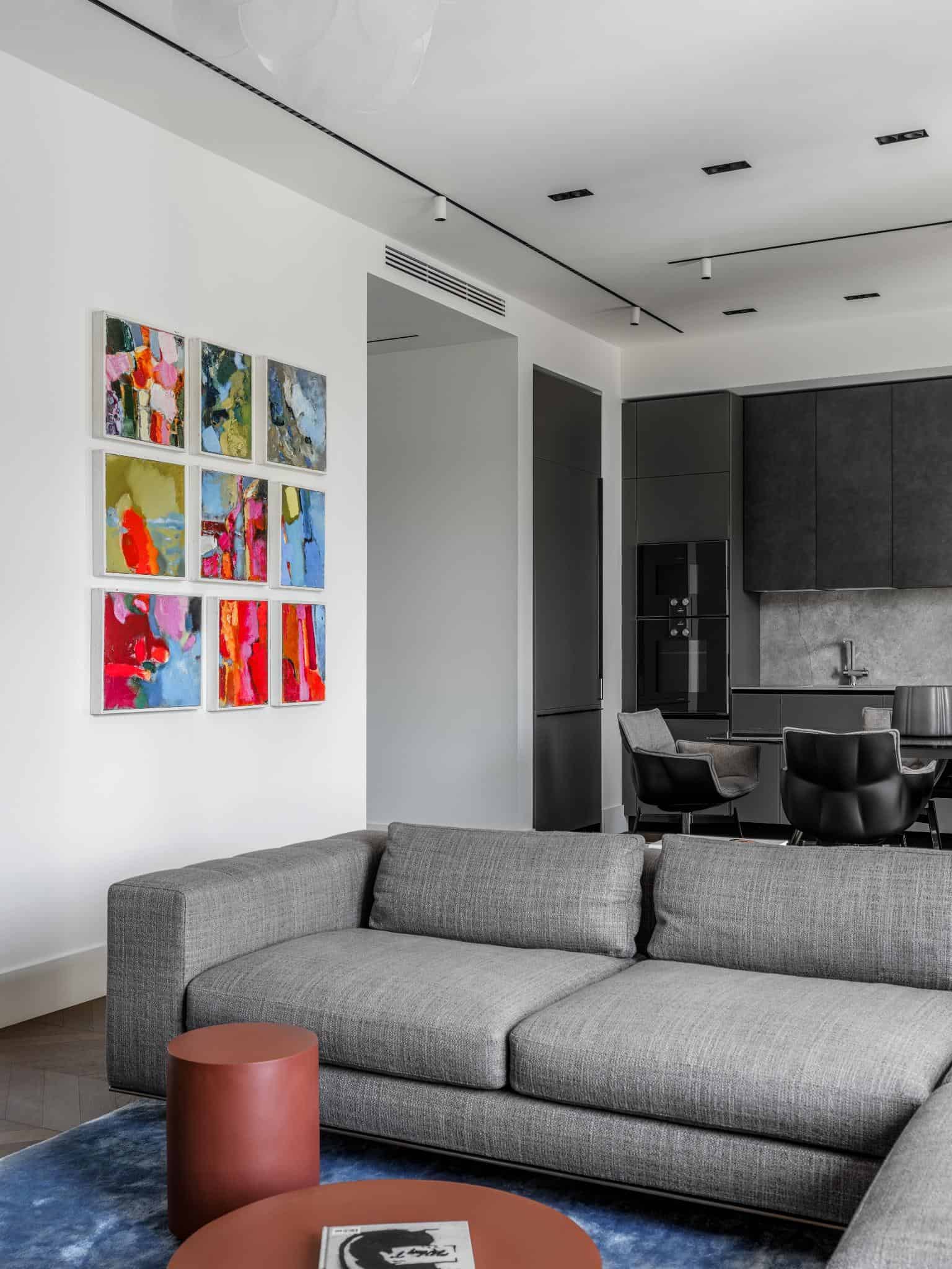 Living Room With Colorful Art And Gray Sofa Living room with colorful art and gray sofa.