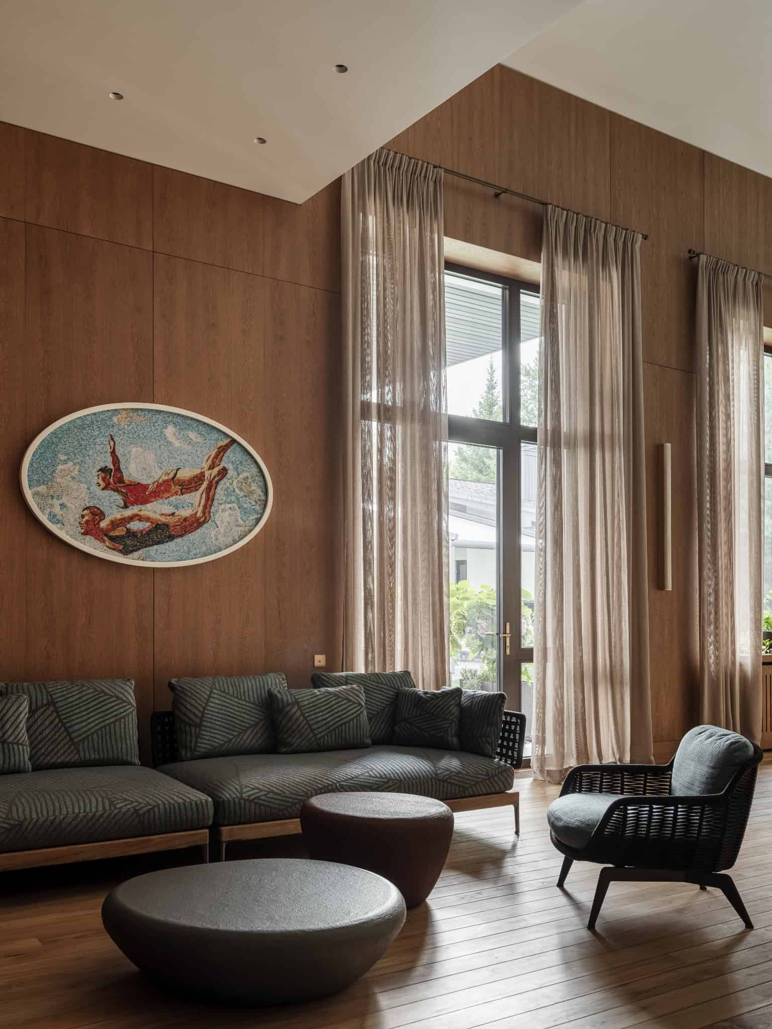 Loft Lounge with Woven Sofa Loft-style lounge area with dark wood paneling and cozy woven furniture.