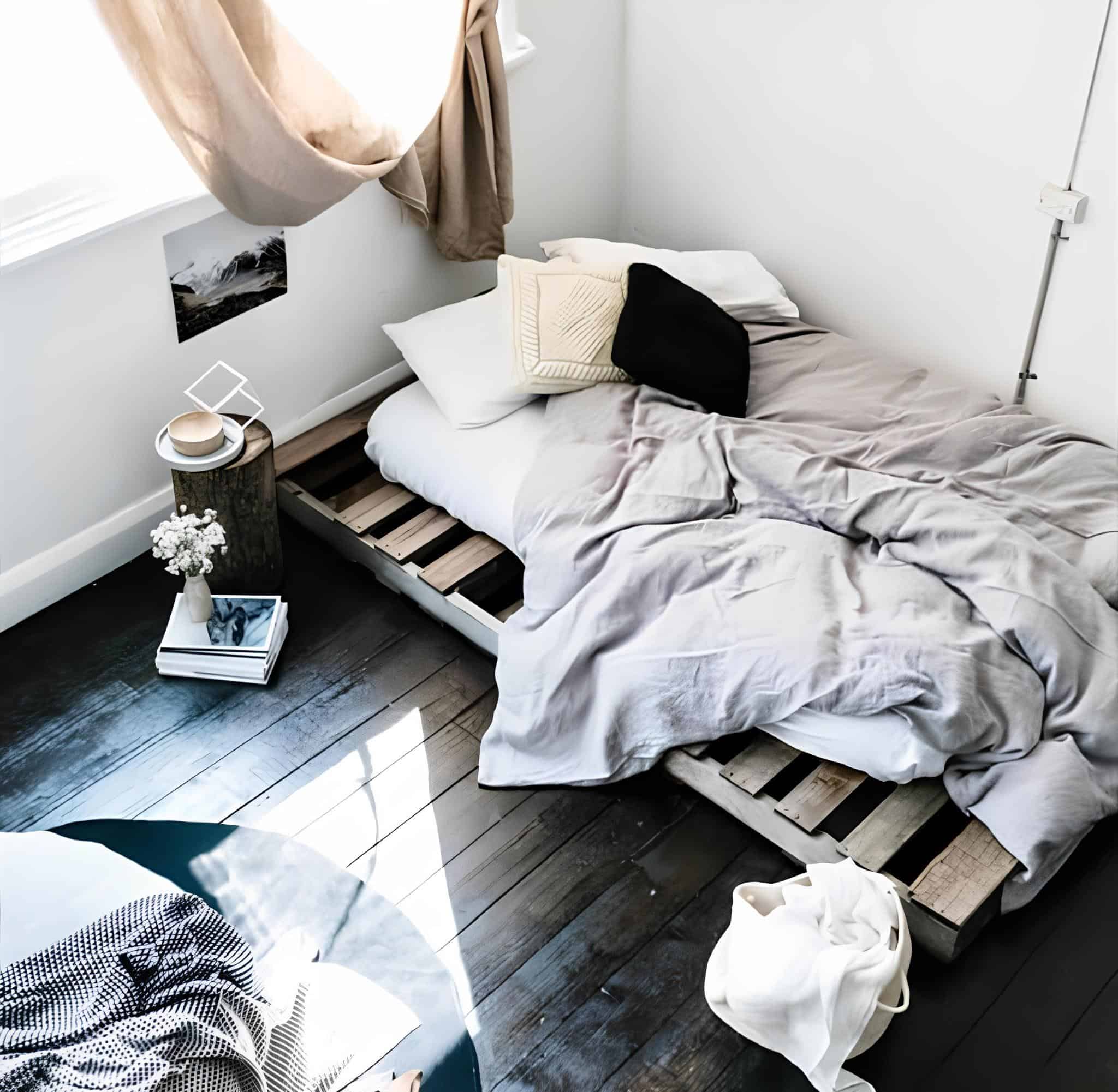 Minimalist bedroom with a low pallet bed frame and neutral bedding