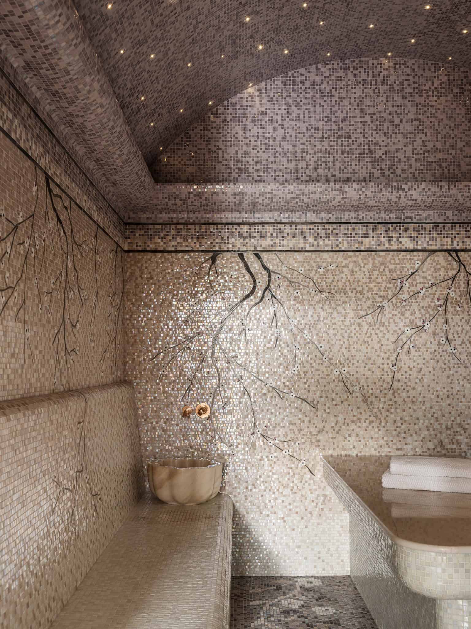 Luxury Hammam Interior with Gold Fixtures Spa-like hammam space with gold taps, natural stone bowls, and glowing ceiling lights.