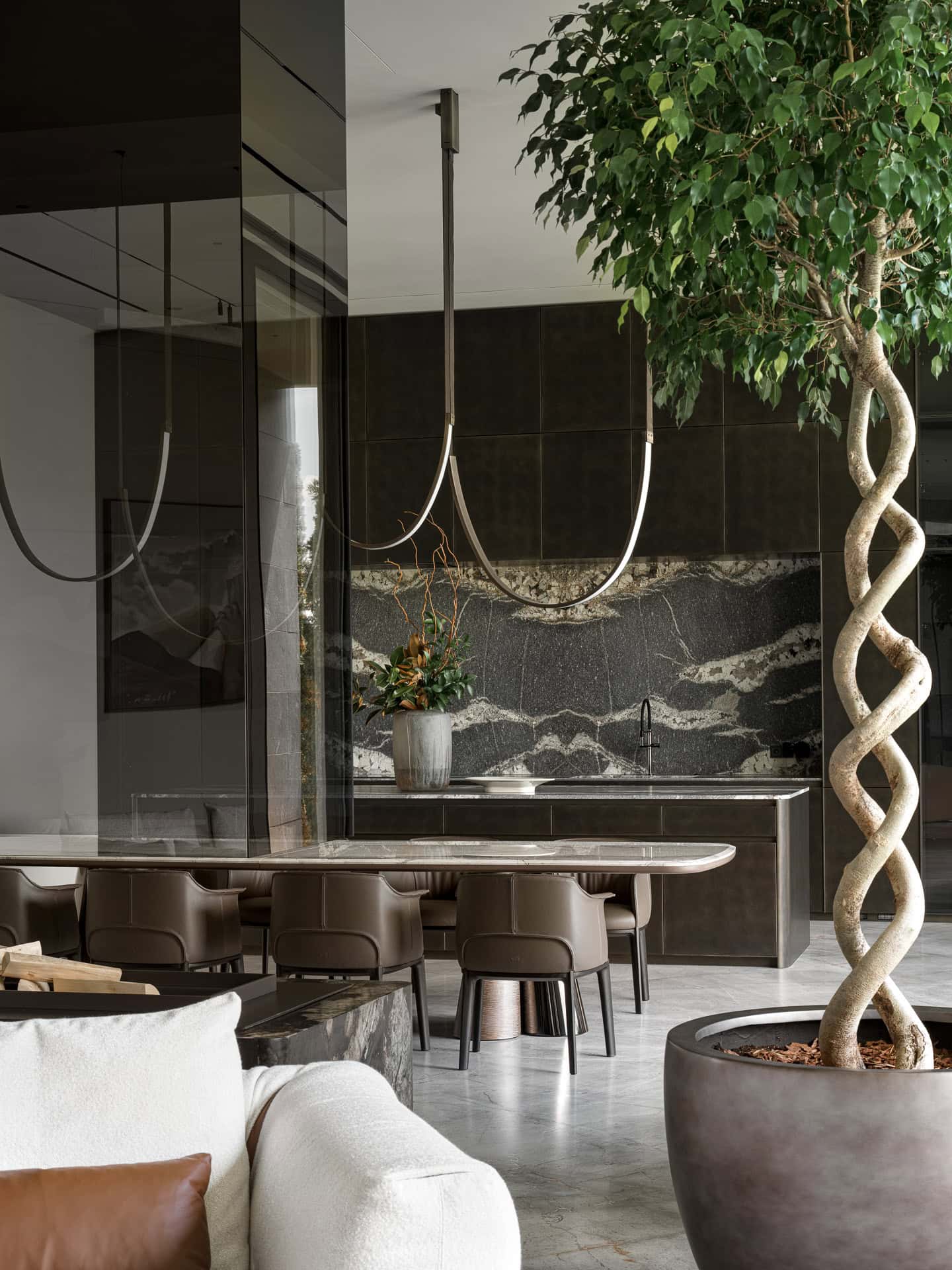 Luxury Kitchen Dining Tree Feature Designer kitchen with marble backsplash and tree planter adjacent to dining area.