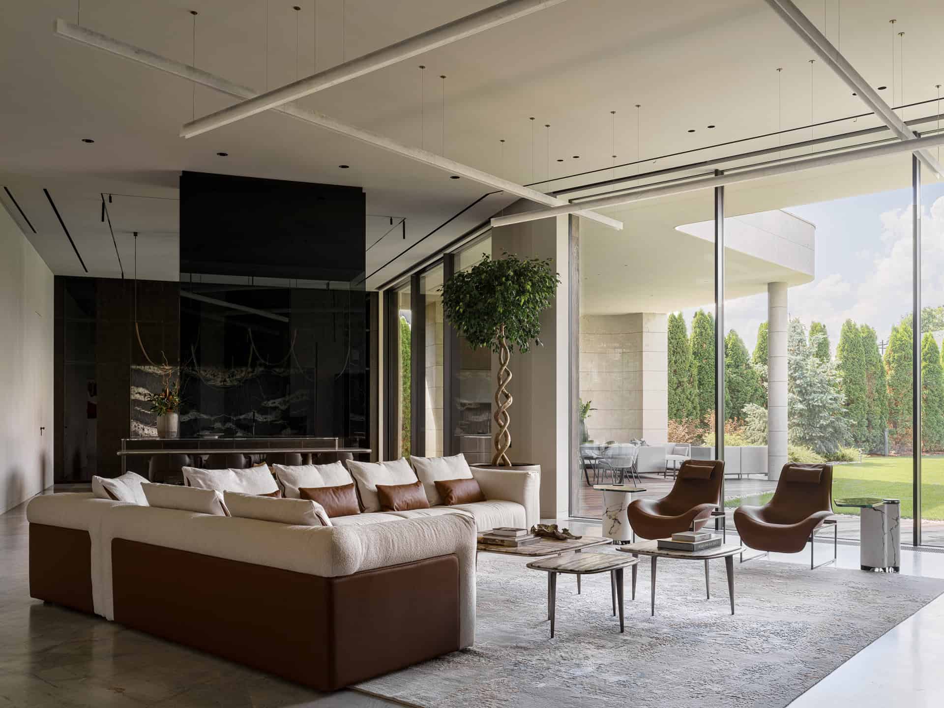 Luxury Living Room Open Garden View Luxury living room with plush sofa and expansive garden view through glass walls.