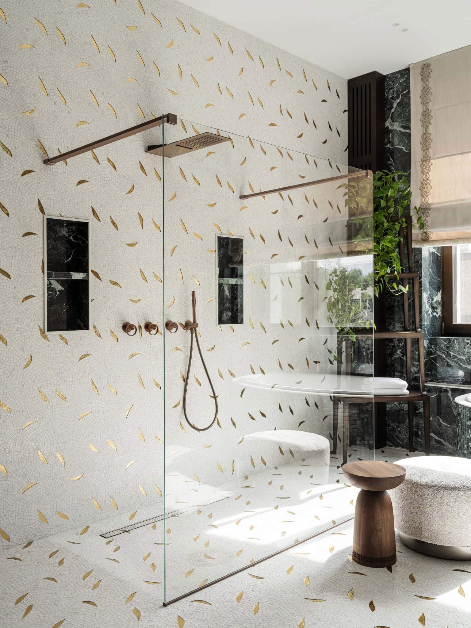 Luxury Walk-In Shower with Gold Details Elegant walk-in shower with white mosaic tiles and gold accent inserts.