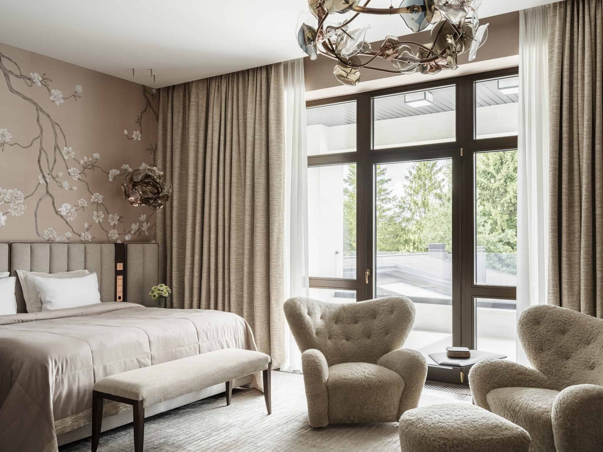 Master Bedroom with Floral Wallpaper Elegant bedroom featuring botanical wallpaper and light-filled sitting area.