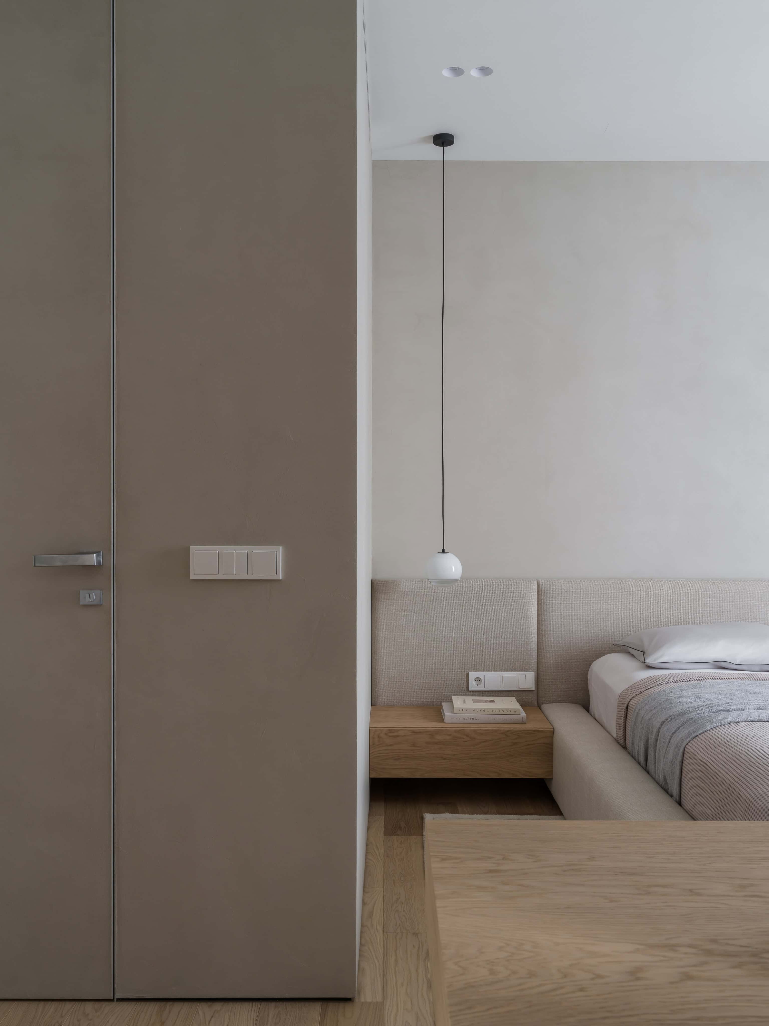 Minimalist Bedroom Wooden Nightstand Contemporary bedroom with wood floating nightstand, pendant lamp, and soft neutral bedding.