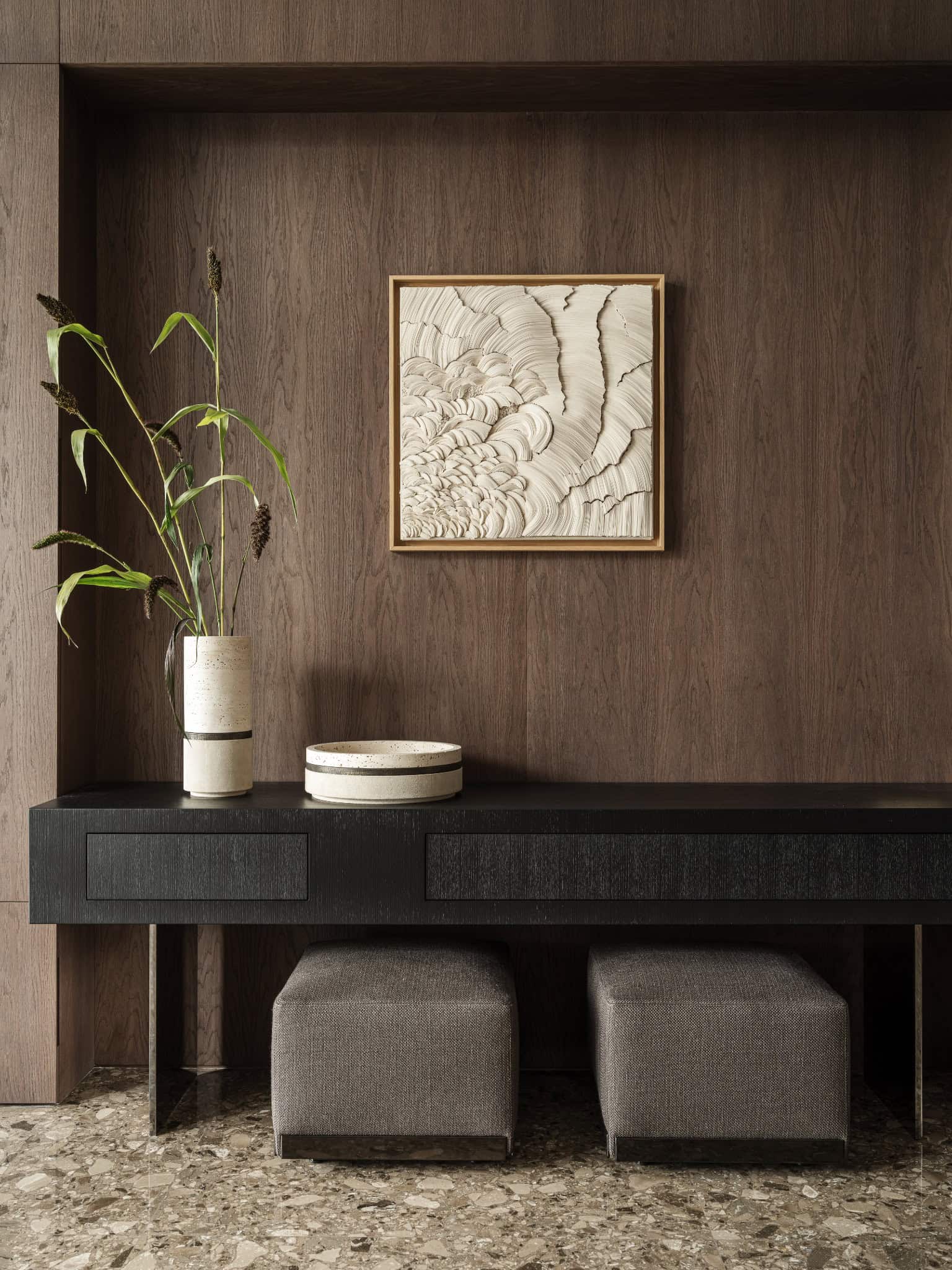 Minimalist Decor Display on Console Table Minimal design with sculptural vases and art framed on a dark console.