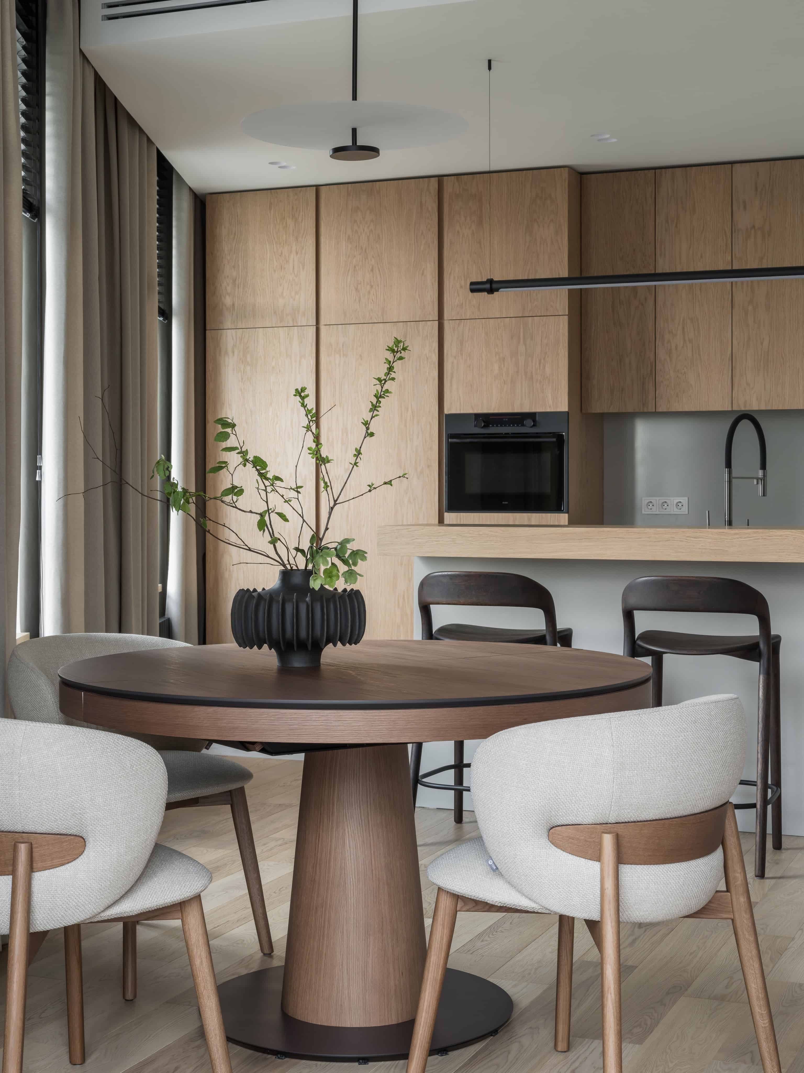 Minimalist Modern Dining Kitchen Design 1 Contemporary kitchen and dining space with natural wood finishes and soft neutral tones.