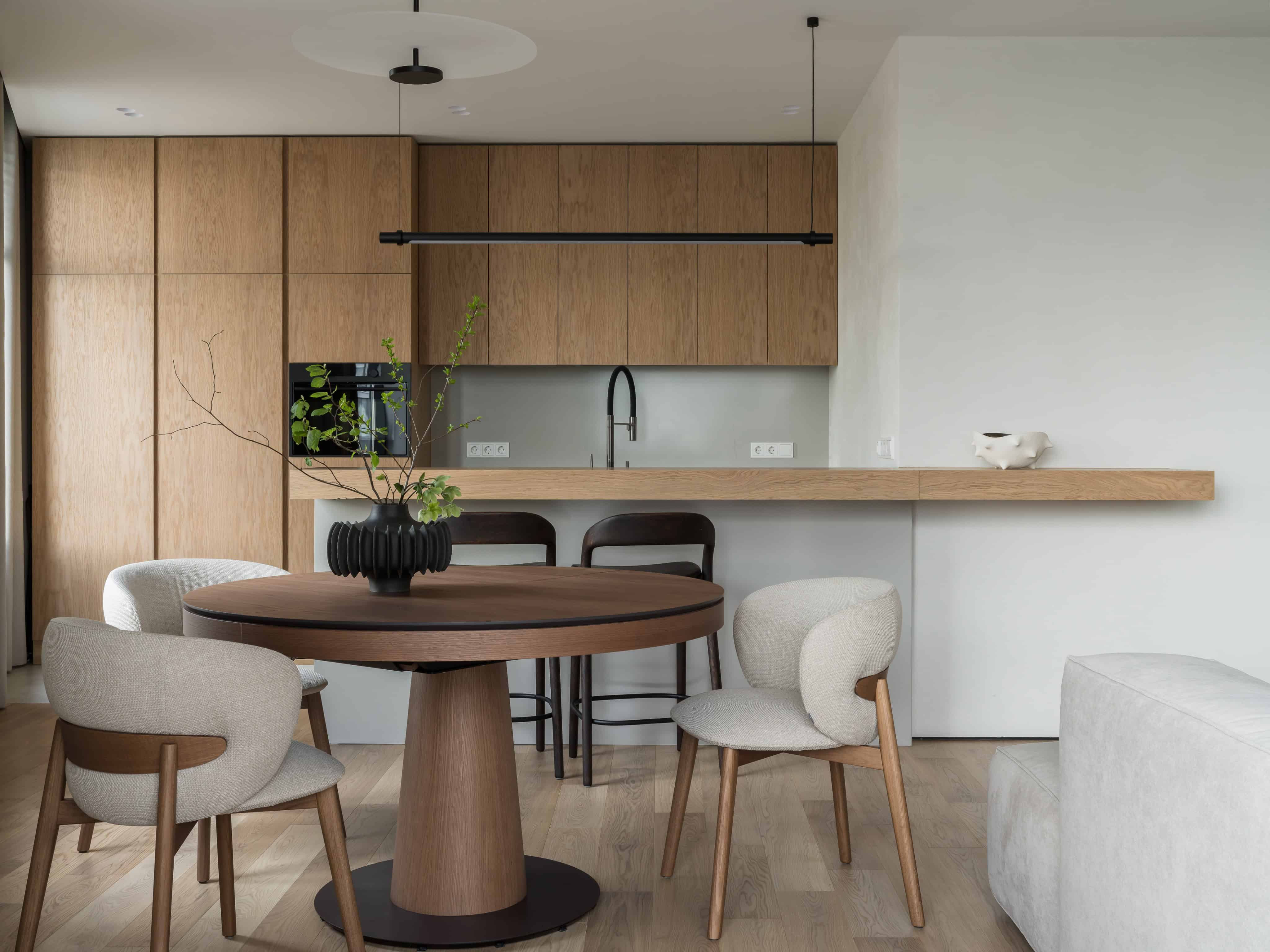 Minimalist Modern Dining Kitchen Design 3 Open kitchen with oak cabinetry, soft lighting, and elegant modern dining furniture.