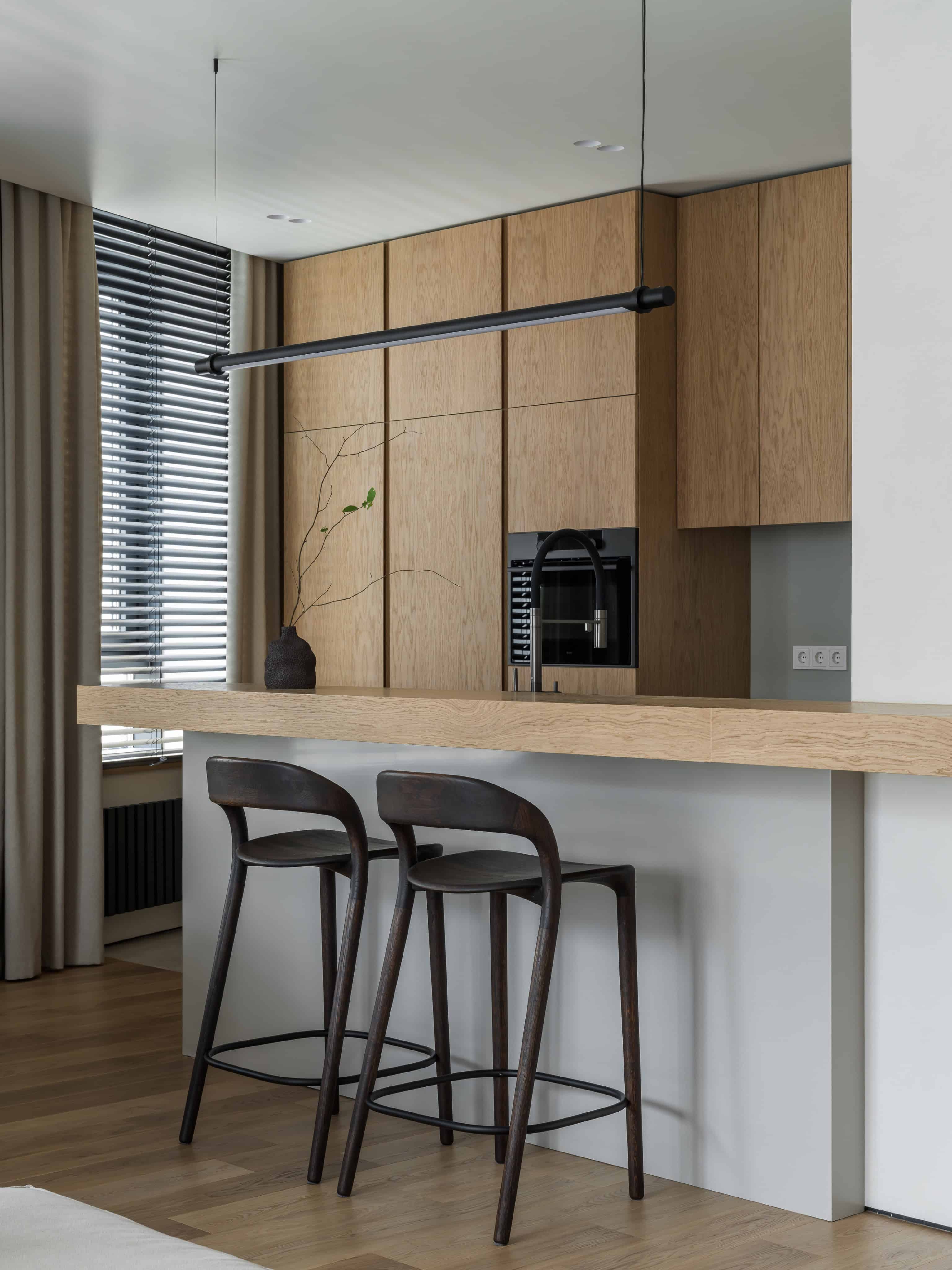 Minimalist Modern Dining Kitchen Design 8 Dining area with modern pendant lighting and cozy upholstered seating by the window.