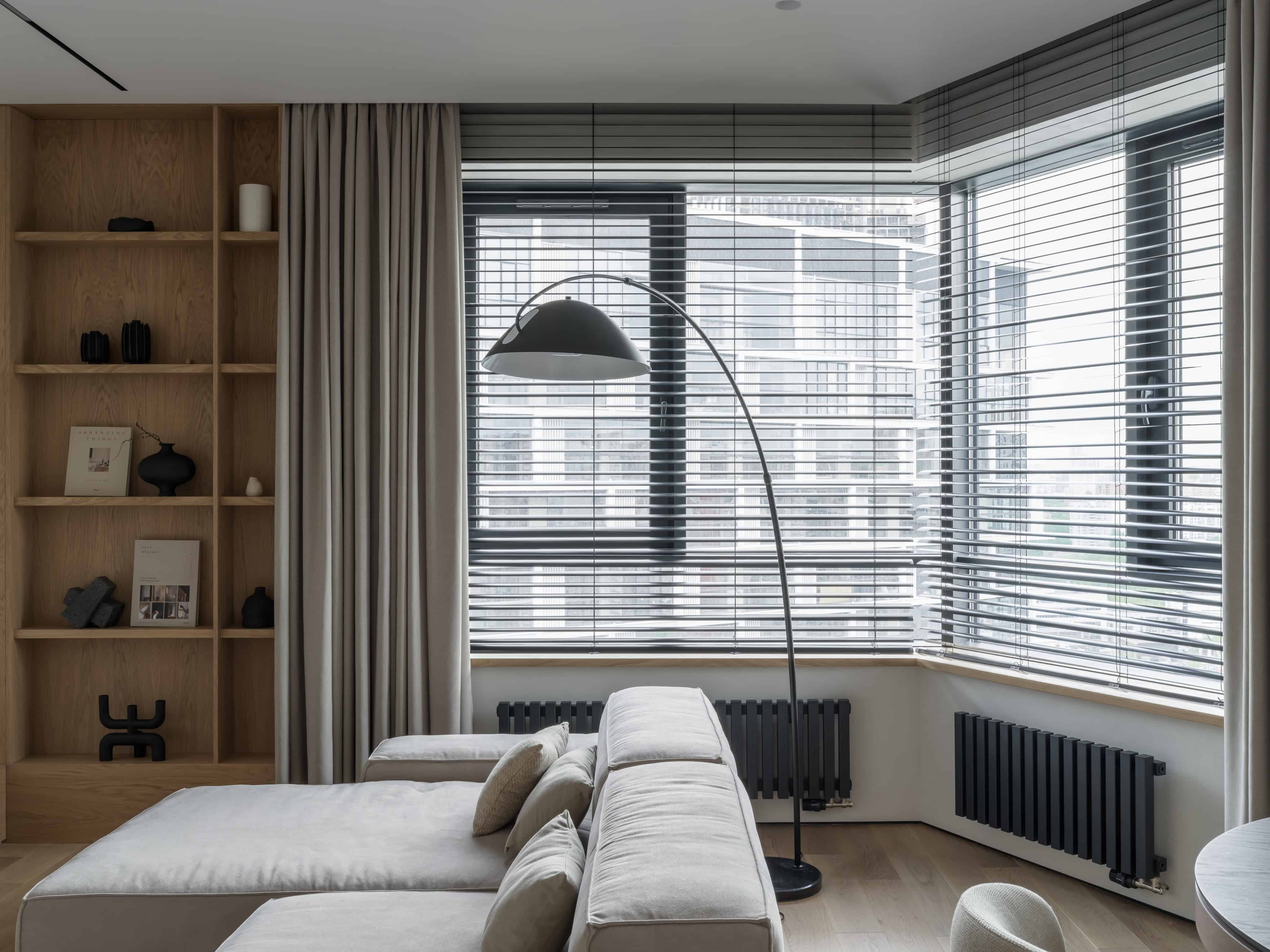 Minimalist Modern Dining Kitchen Design 9 Cozy living corner with panoramic windows, soft seating, and built-in shelving.