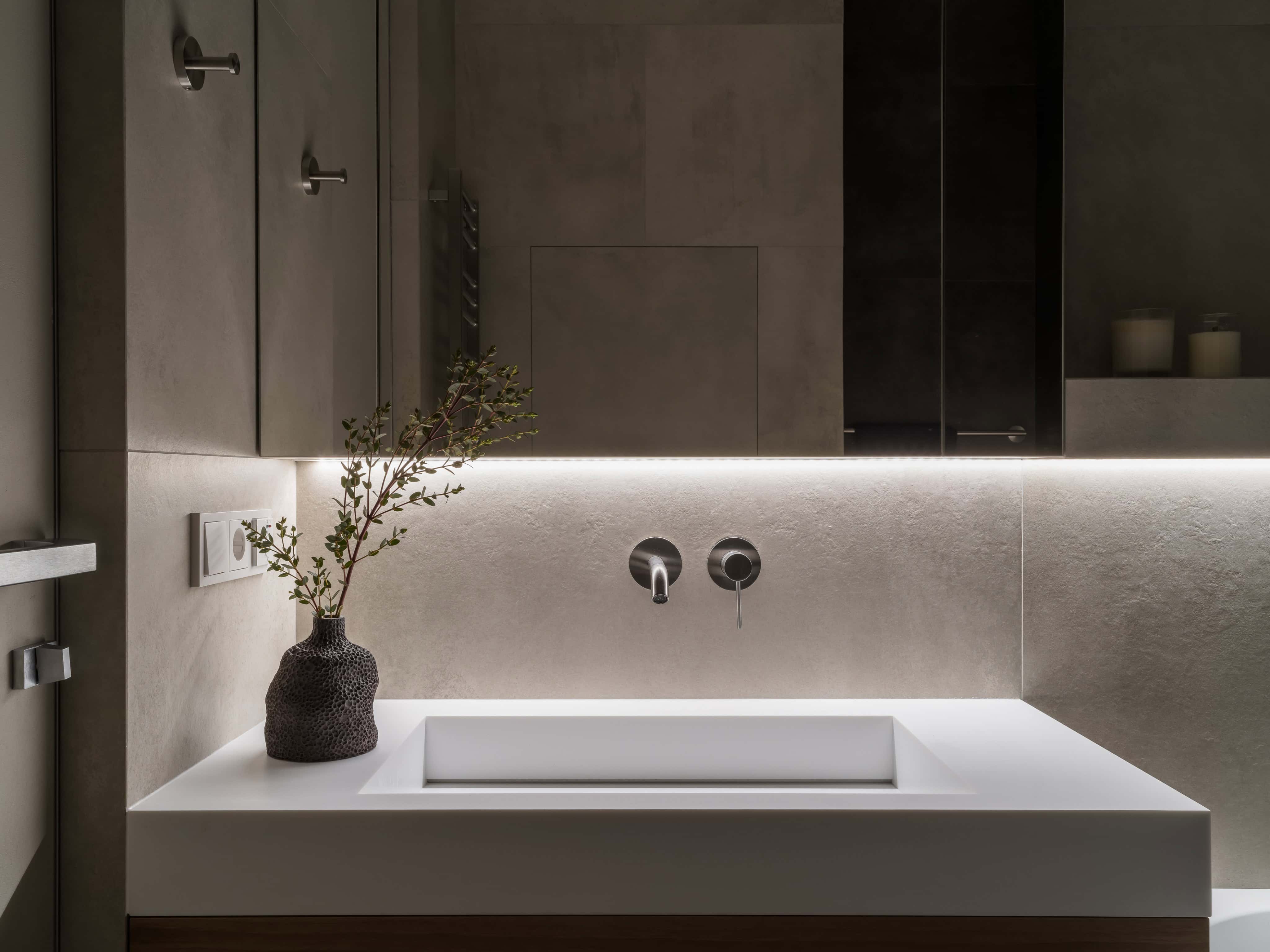 Modern Bathroom Sink Design Closeup Close-up of a modern rectangular sink with integrated lighting and textured ceramic decor.