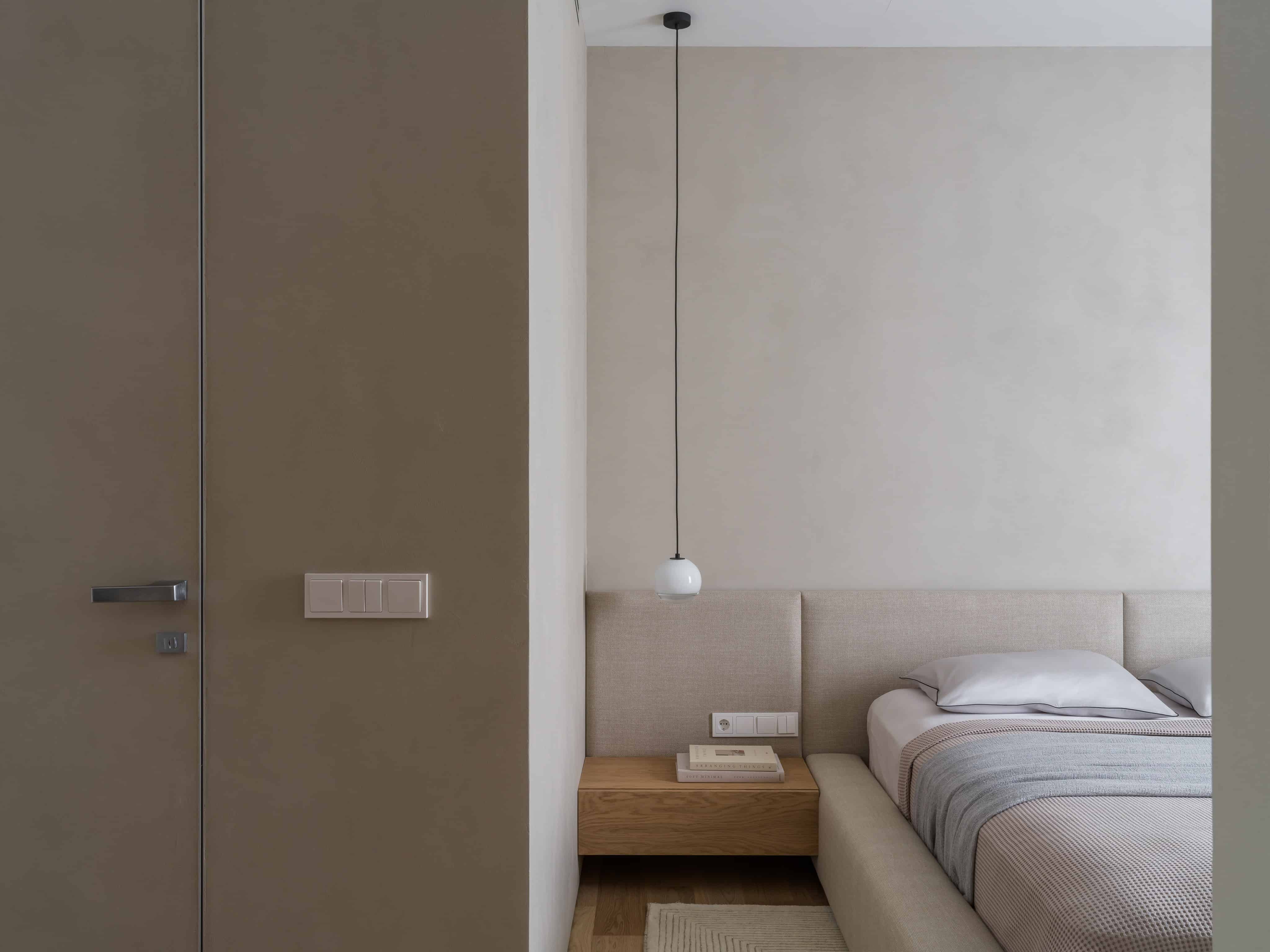 Modern Bedroom Light Pendant Over Bed Minimalist bedroom design featuring a pendant lamp and headboard integrated with wall paneling.