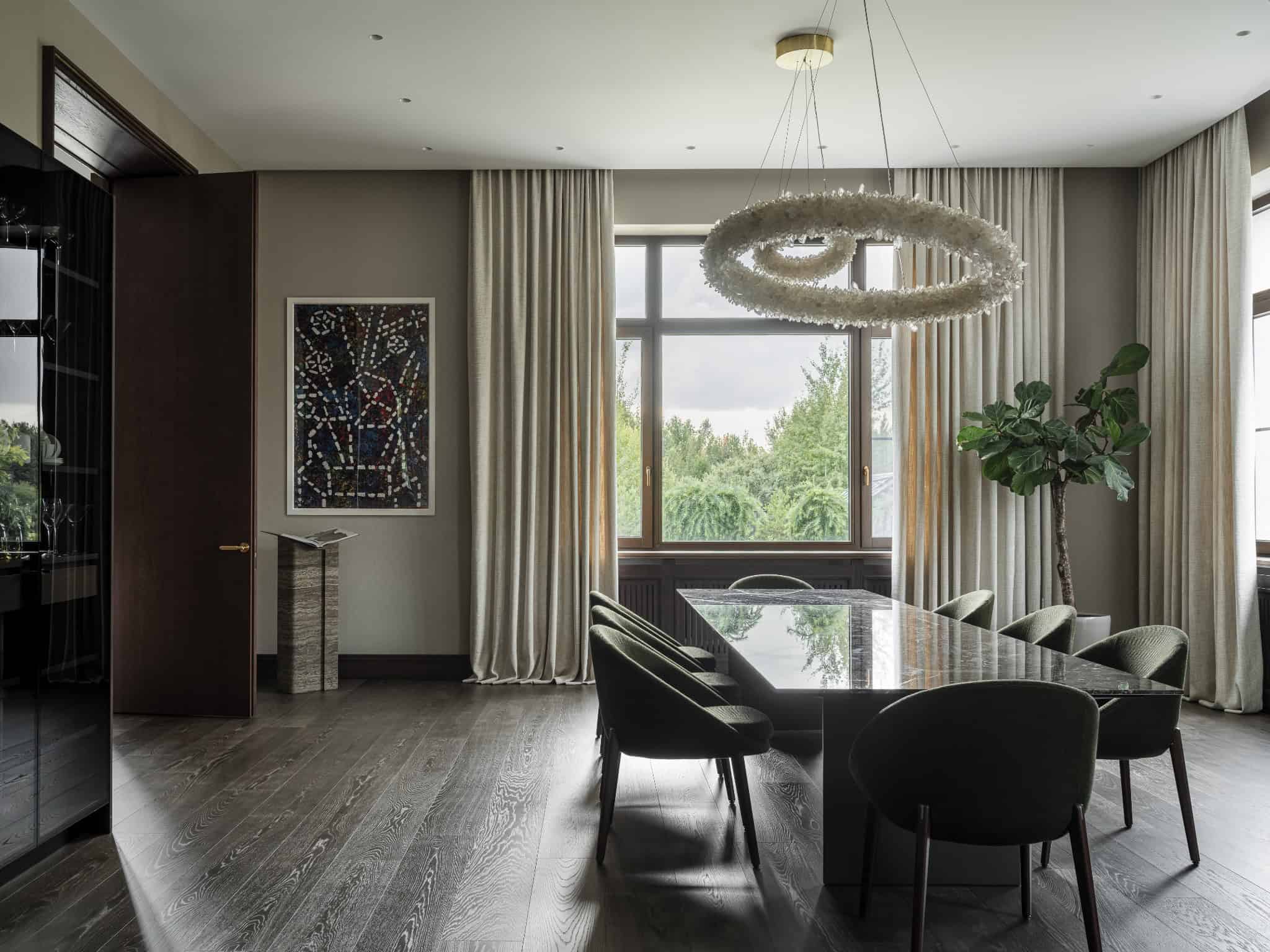 Modern Dining Room with Crystal Chandelier Sophisticated dining space with crystal chandelier and floor-to-ceiling curtains.