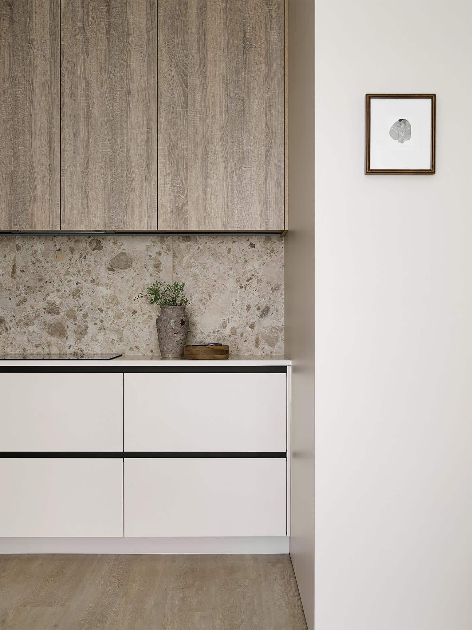 Modern Kitchen Design Close-Up View Close-up of modern beige kitchen with wood cabinets and textured backsplash.