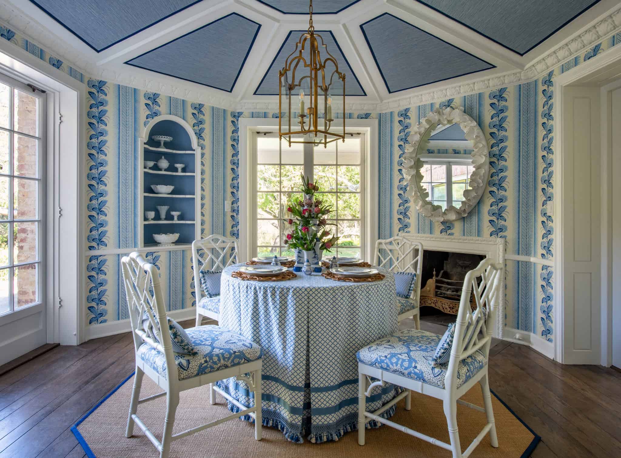 Morning Room Blue Pattern Walls Nolasco Studios Octagonal morning room with blue and white patterned wallpaper, skirted table, and detailed ceiling.