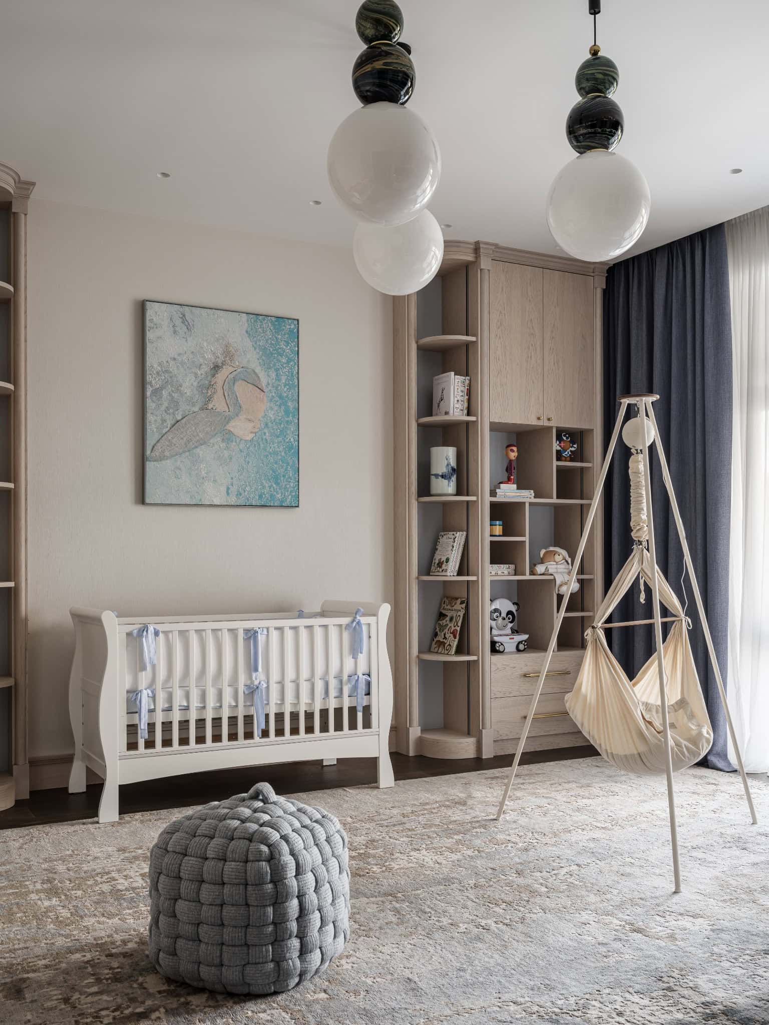 Nursery Room with Crib and Hammock Swing Light-filled nursery with a white crib and baby hammock in neutral tones.