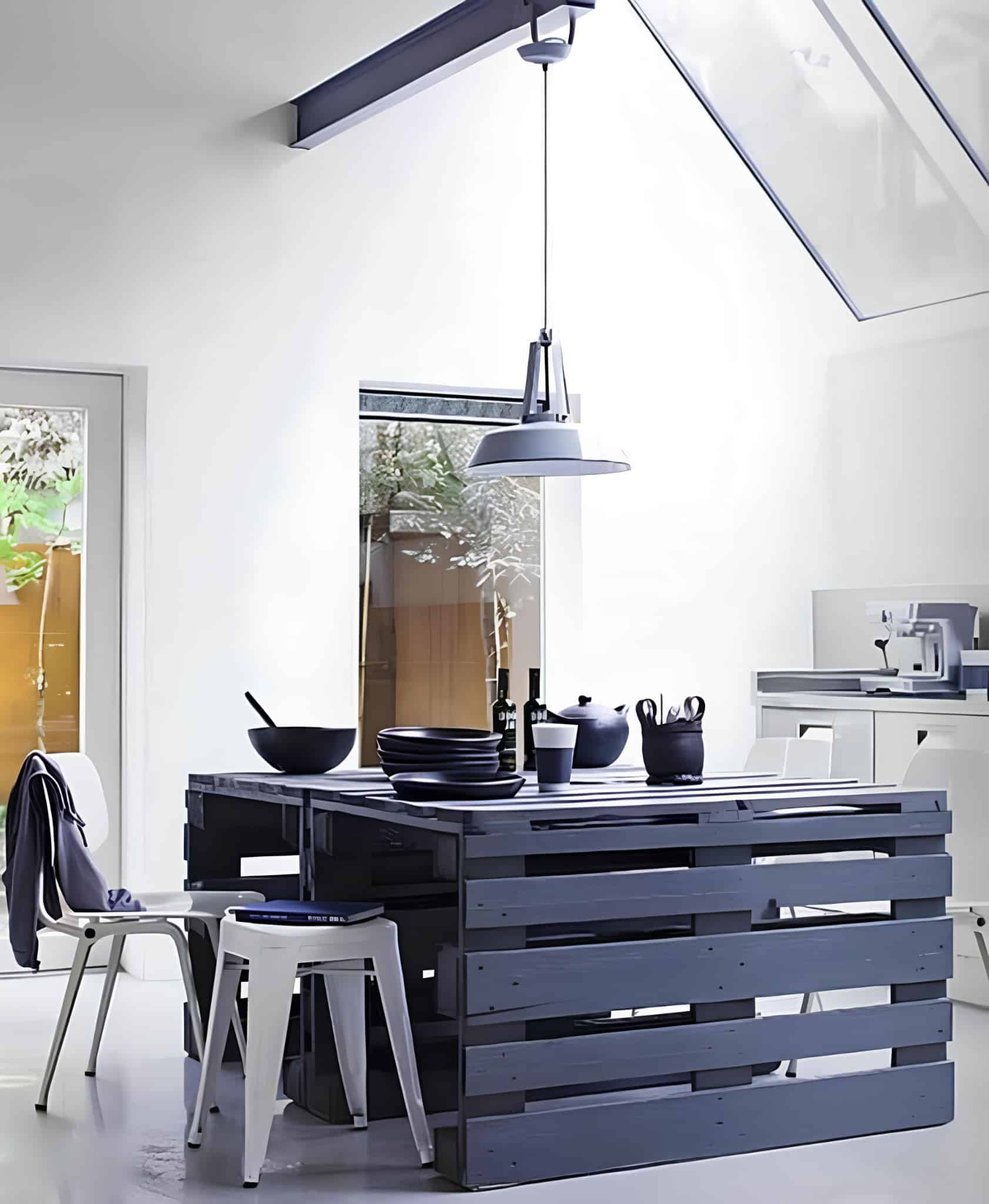 Stylish black-painted pallet dining table paired with minimalist white chairs.