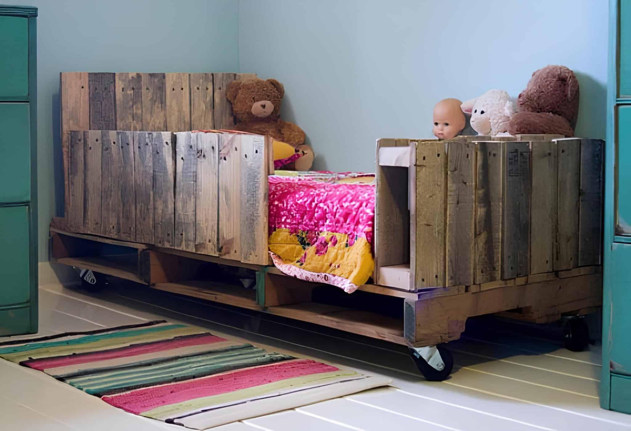 Creative children's bed made from rustic pallets with safety side panels and wheels.