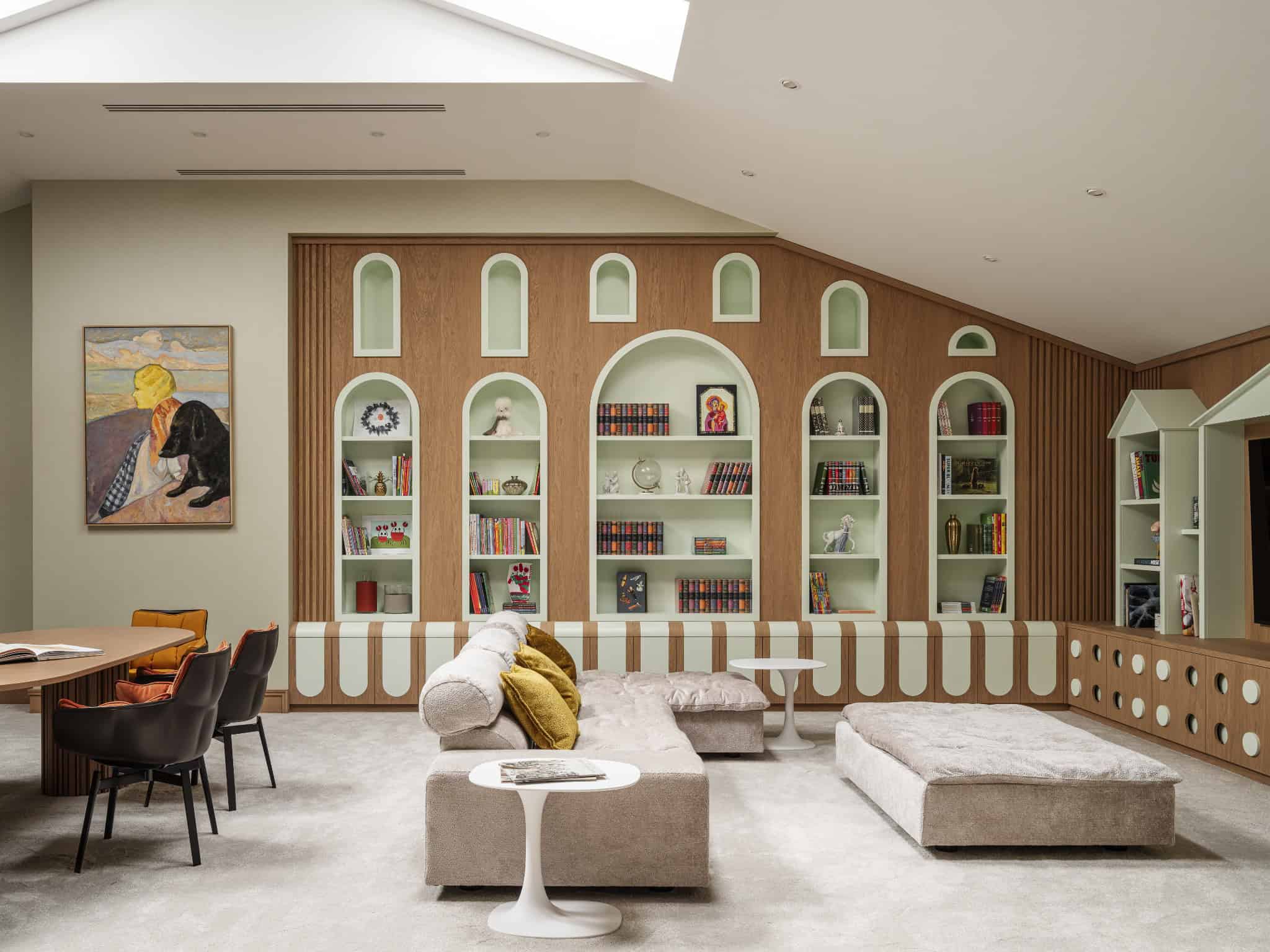 Playroom with Custom Wood Tree and Slide Whimsical kids’ playroom with custom wood tree structure and play equipment.