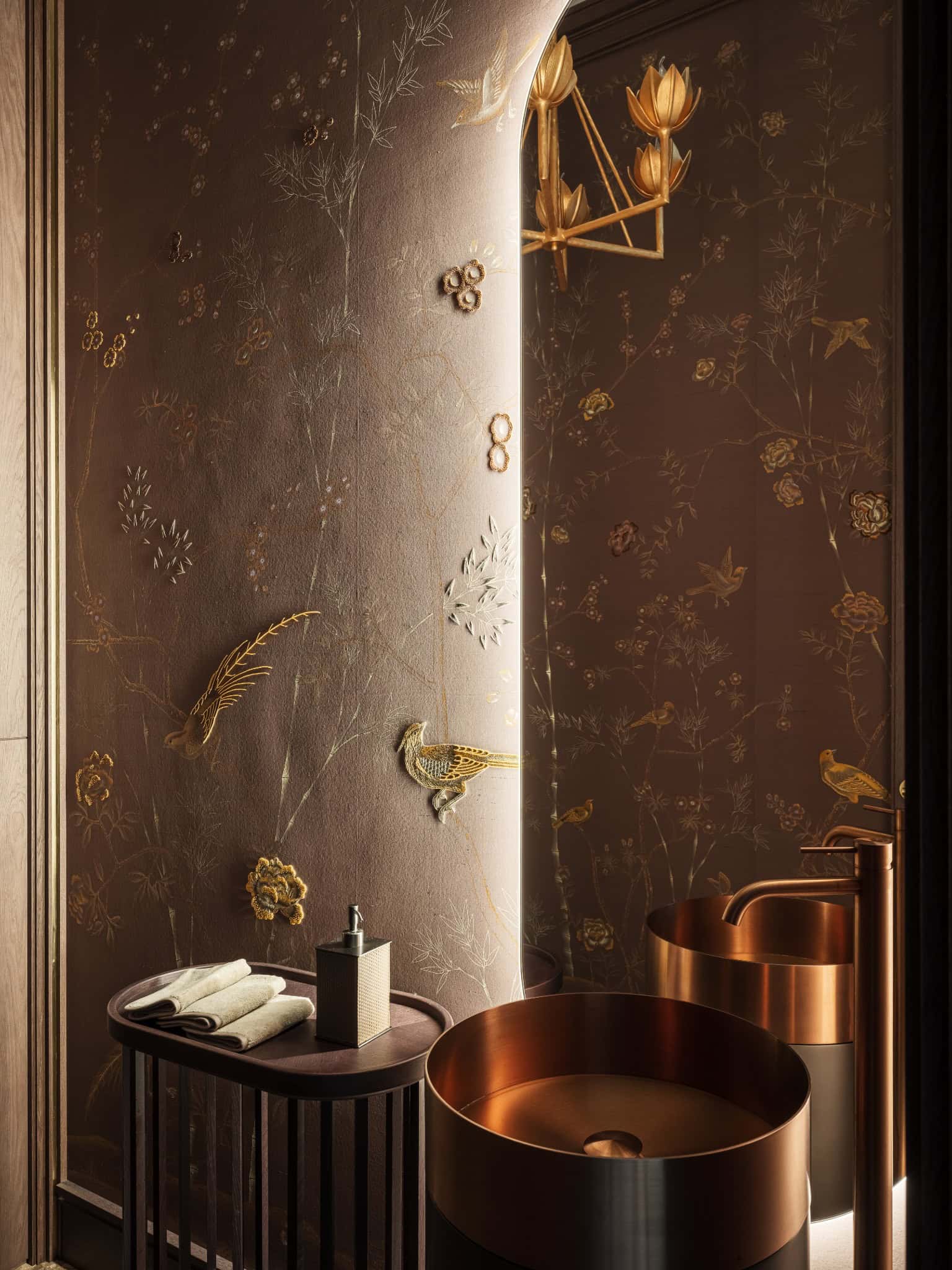Powder Room with Embossed Wall Detail Close-up of decorative wallpaper with golden birds and floral textures in powder room.