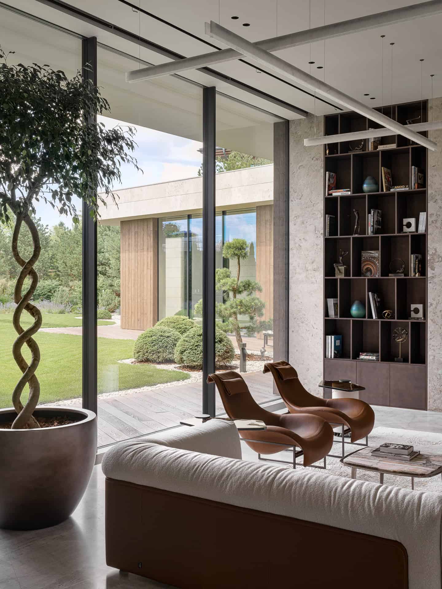 Reading Nook with Panoramic Garden View Cozy reading nook with designer chairs and full-height windows facing the garden.