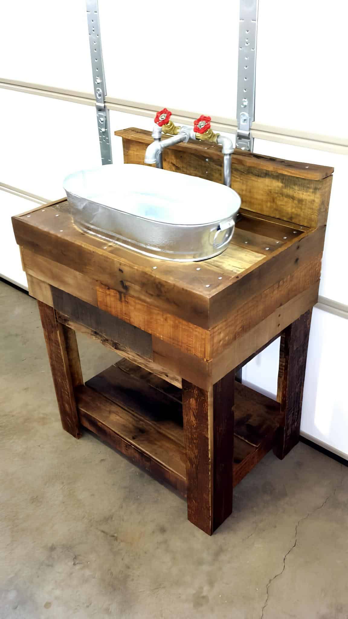 Handmade pallet wood sink stand with a galvanized steel basin