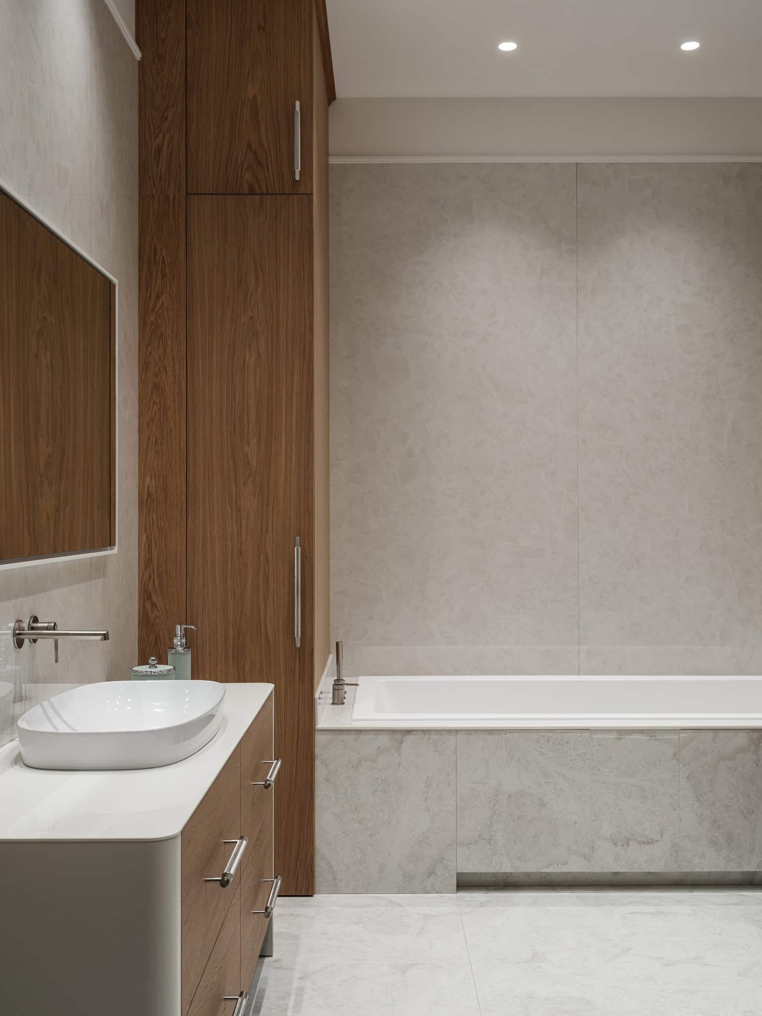 Simple Bathroom with Wood Accents Minimalist bathroom with built-in tub and wooden cabinetry.