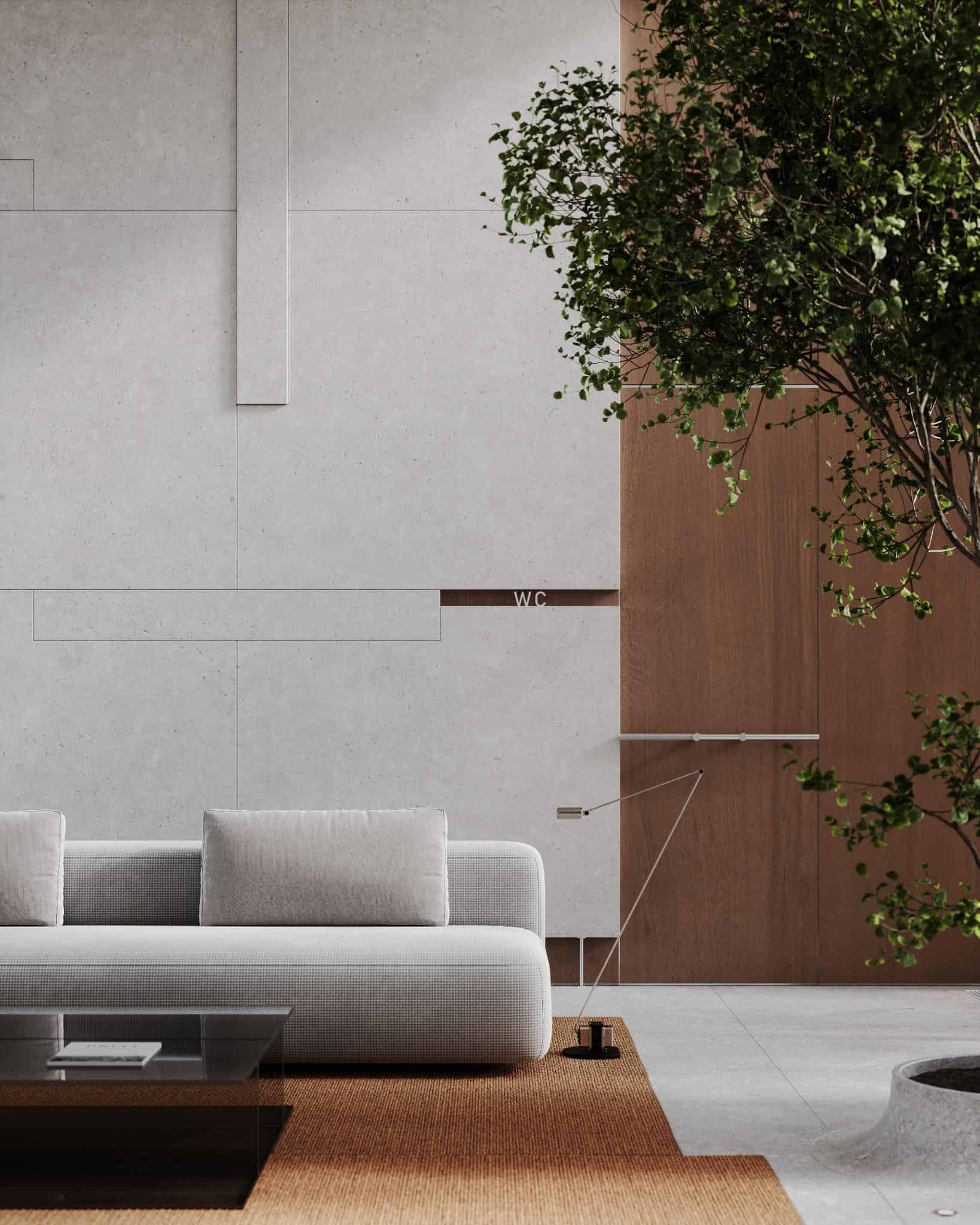 Soft Gray Sofa with Indoor Tree in Modern Lobby Modern lobby corner with soft gray sofa, brown carpet, and indoor tree near concrete wall.