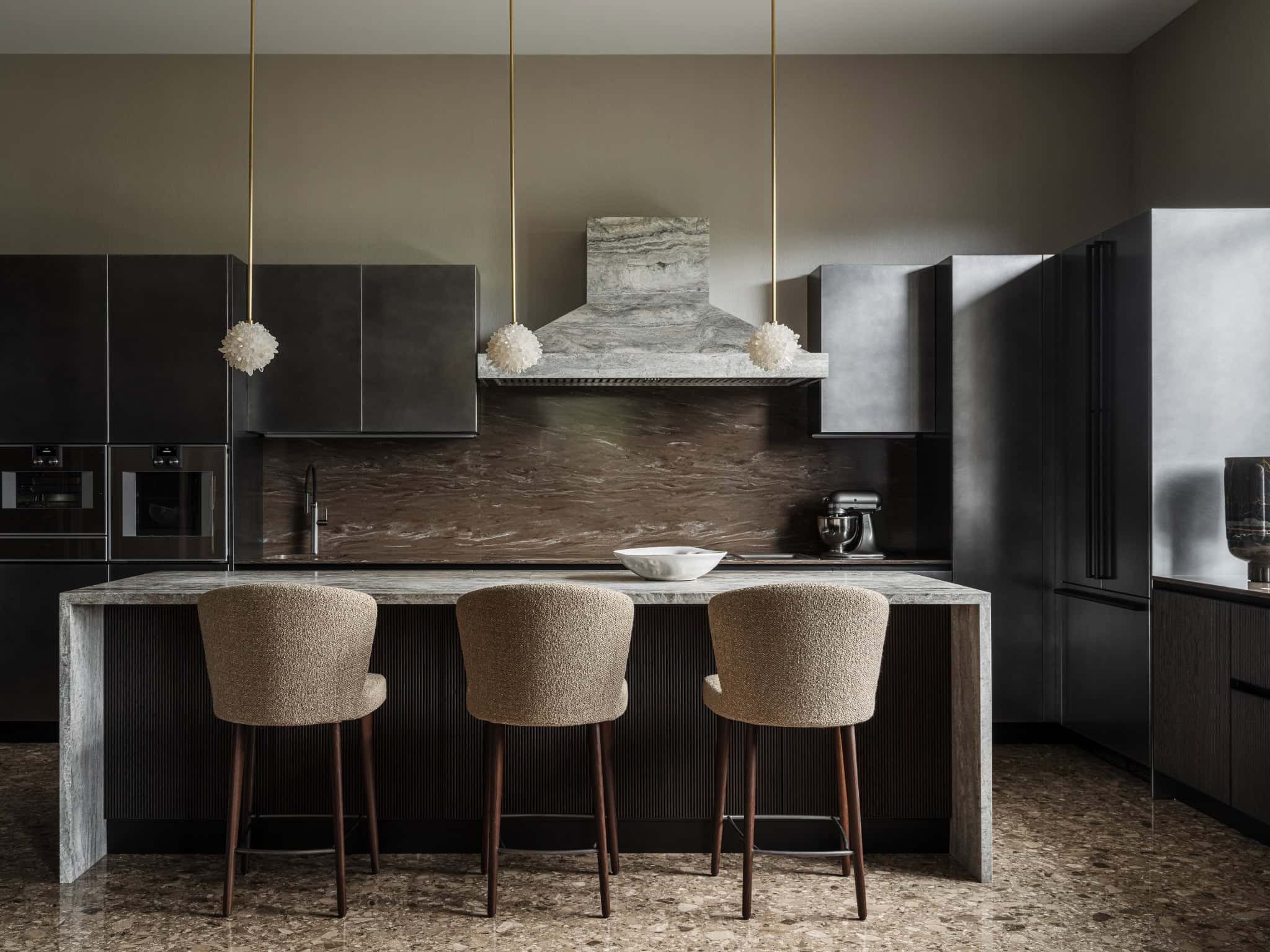 Sophisticated Kitchen with Marble Island Stylish modern kitchen featuring marble island and pendant lighting.