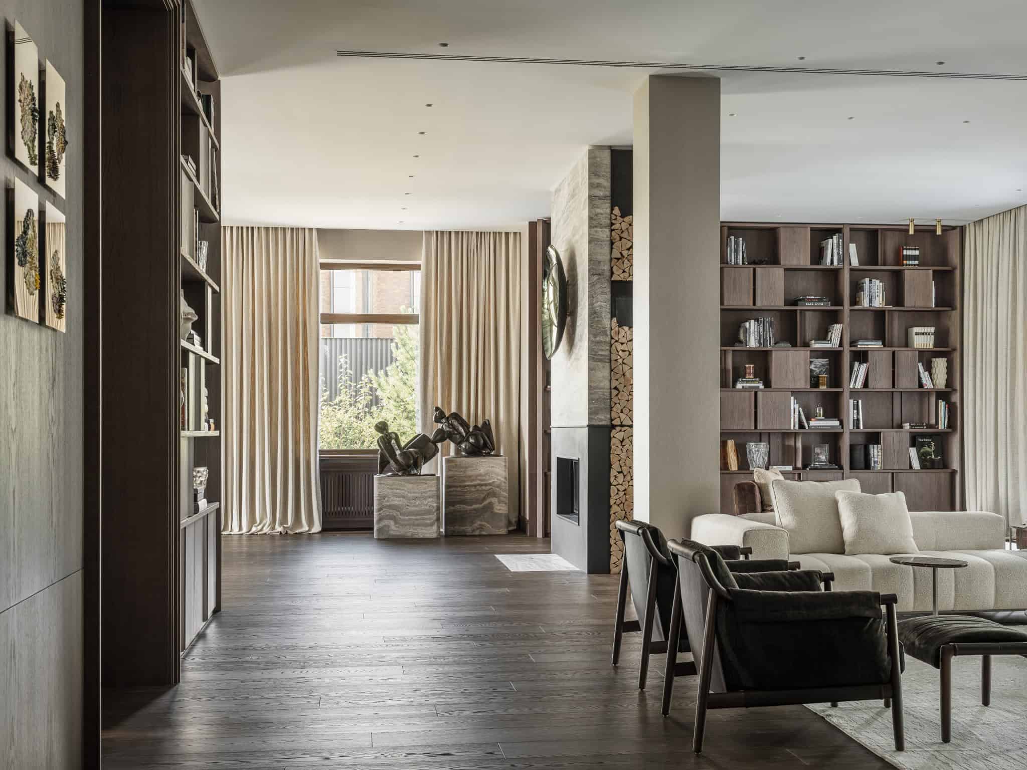 Spacious Living Room with Floor to Ceiling Windows Luxurious living room with dark wood flooring and natural light from tall windows.
