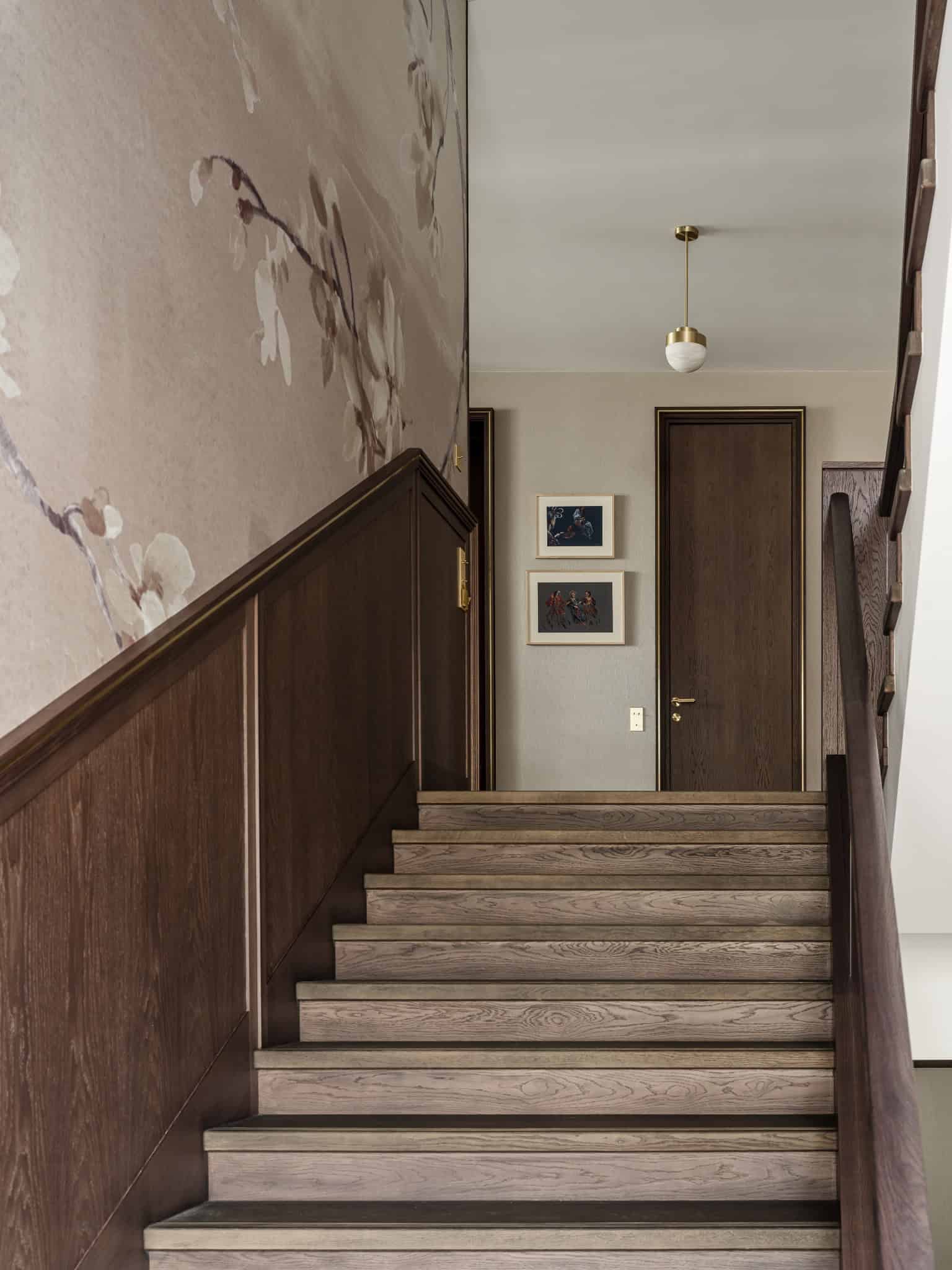 Staircase Landing with Floral Wall Mural Upper landing with staircase featuring a subtle floral wall mural and framed art.