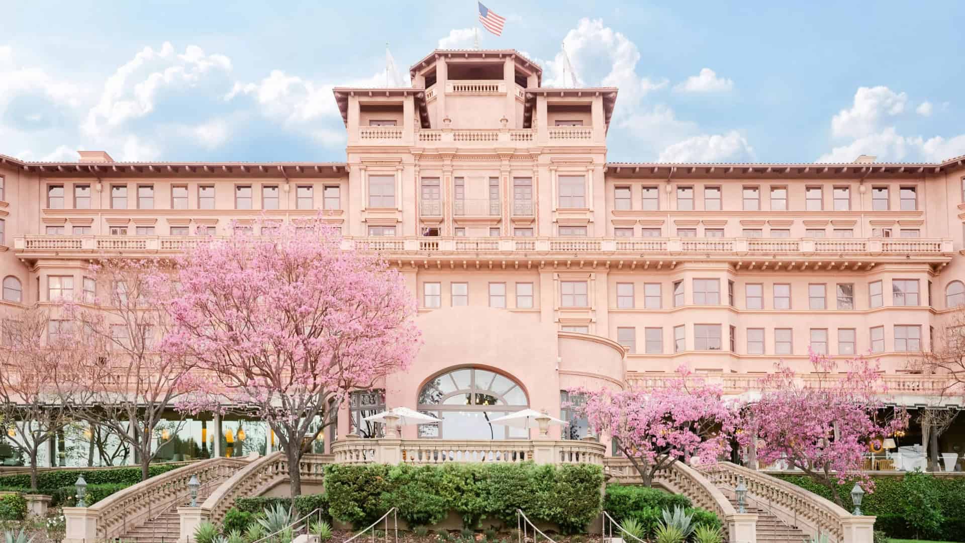 The Langham Hotel Pasadena Exterior Pink The Langham Hotel exterior with classical architecture and blooming pink trees.