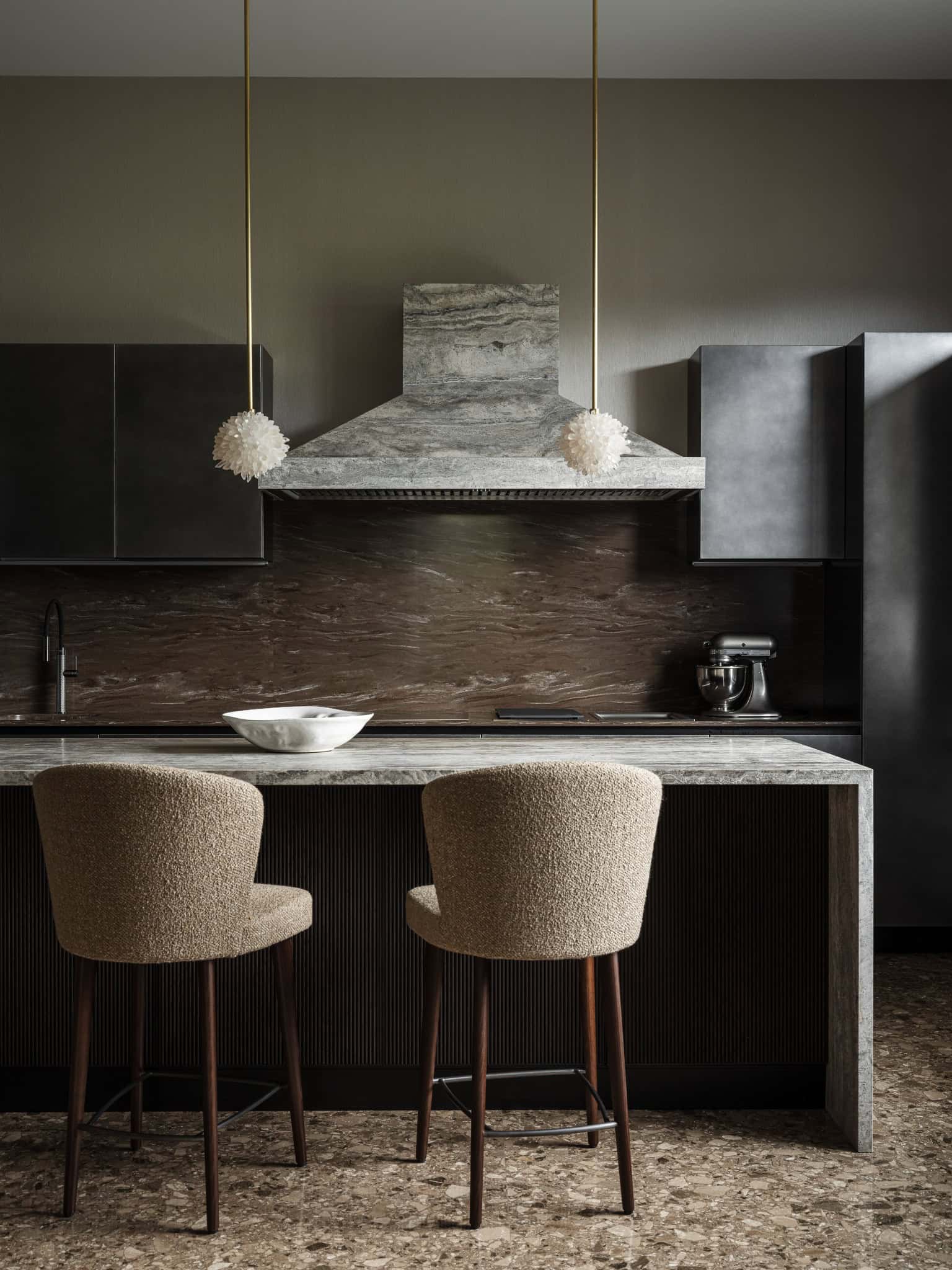 Two Upholstered Barstools at Marble Counter Close-up of barstools with soft fabric at a marble countertop.