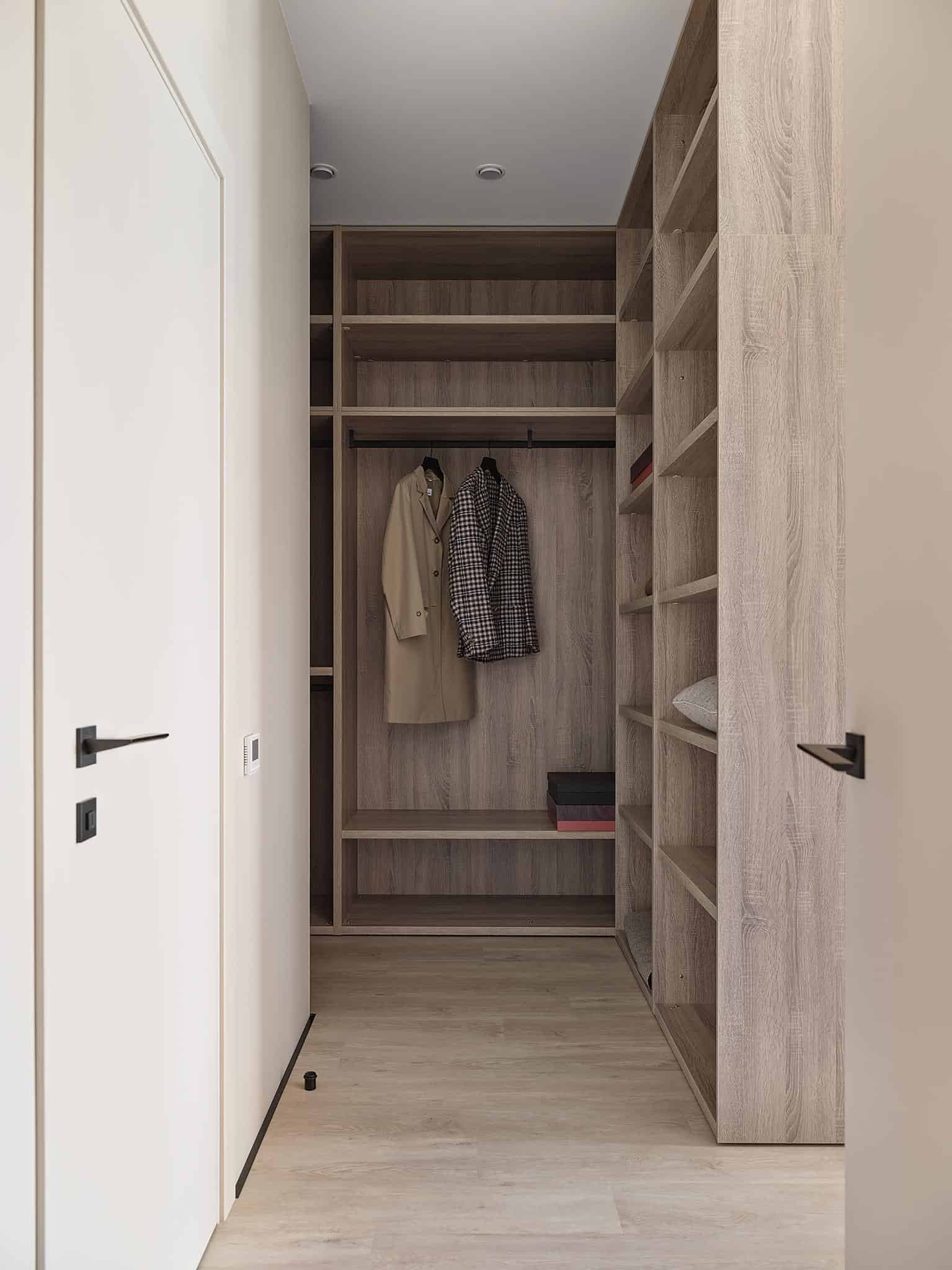 Walk-In Closet Design with Wooden Shelves Spacious walk-in closet with open wooden shelving and light wood flooring.