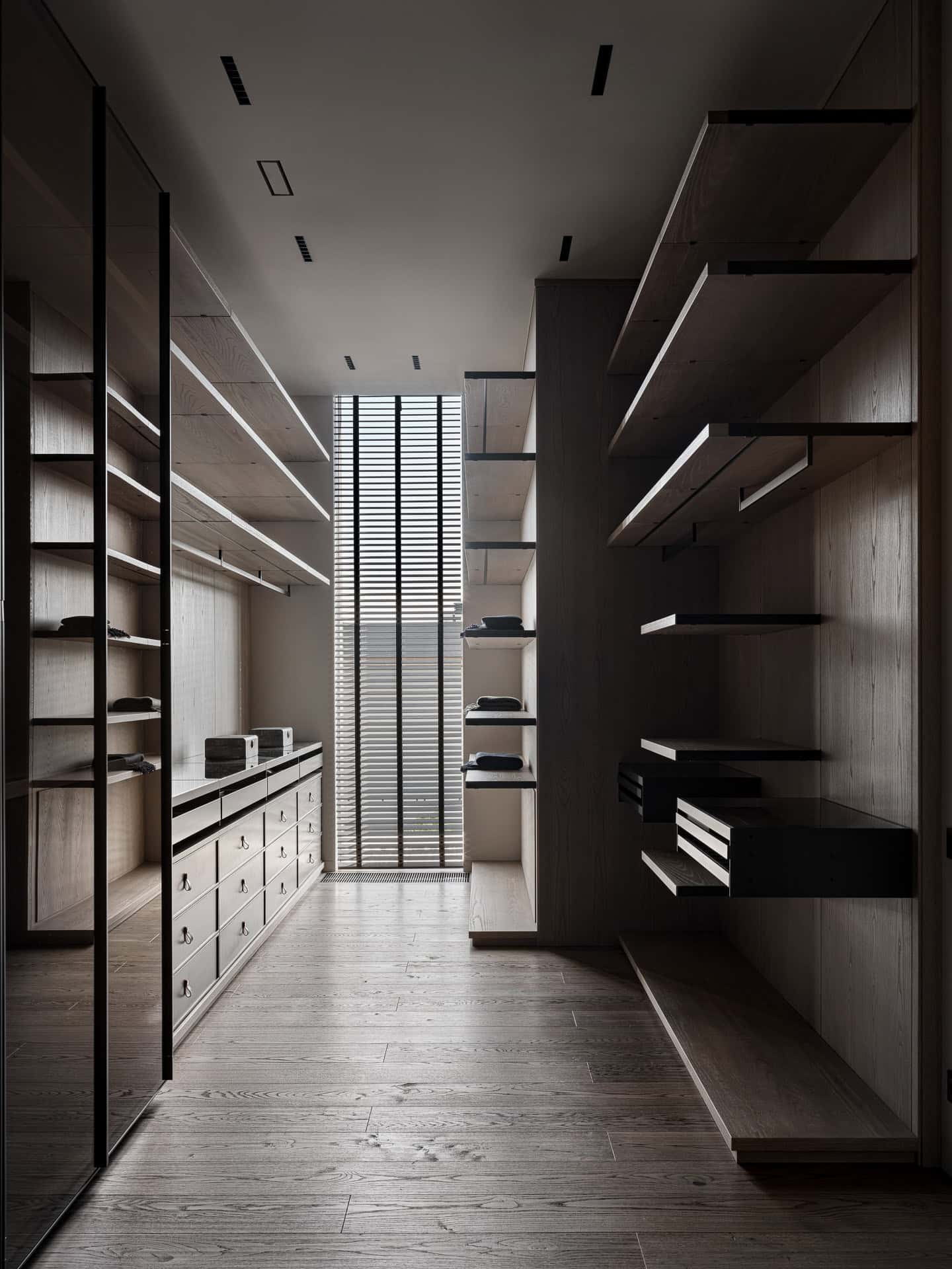 Walk-In Closet Open Shelving Spacious walk-in closet with open wooden shelving and floor-to-ceiling mirror.