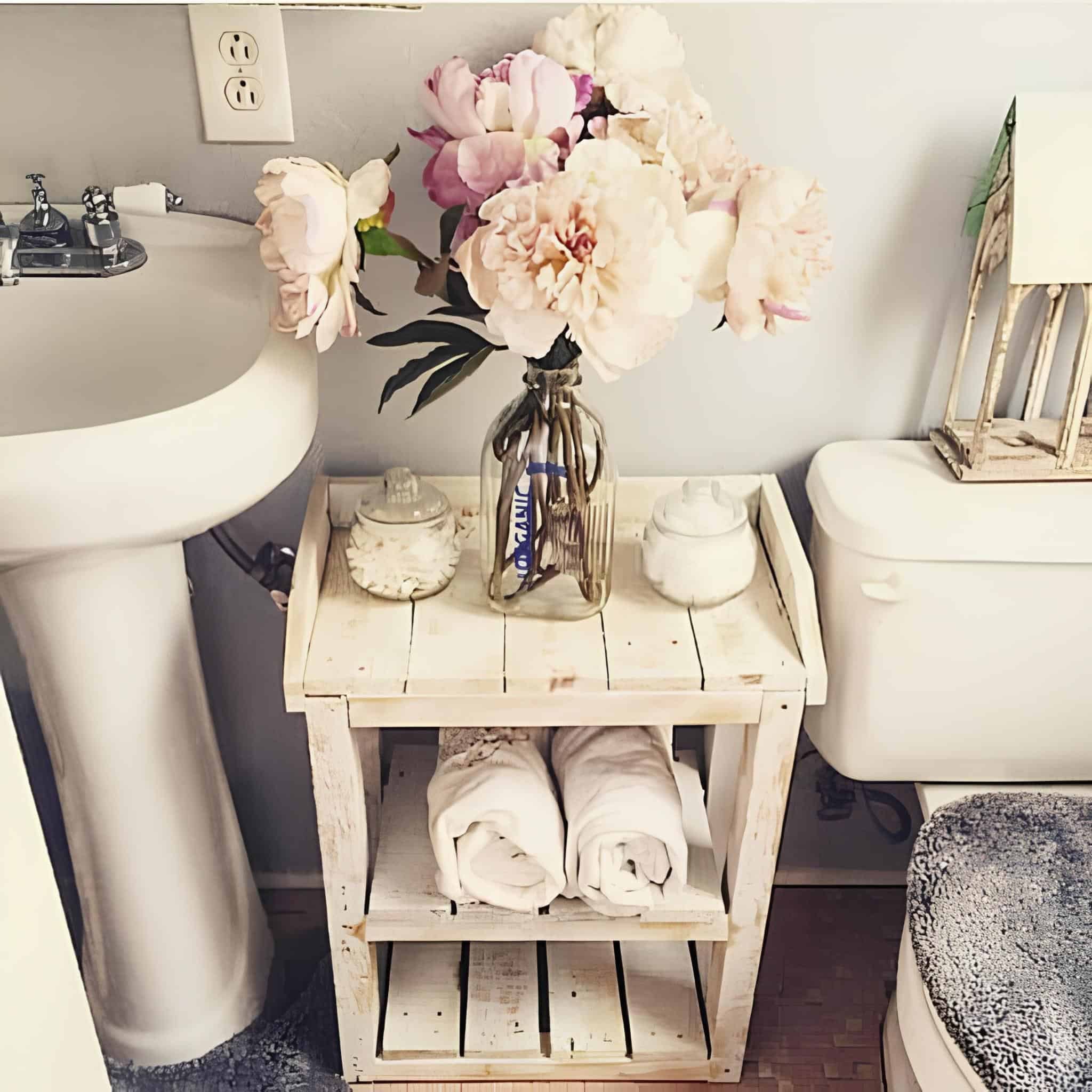 Bathroom crate shelf painted white and styled with towels and flowers