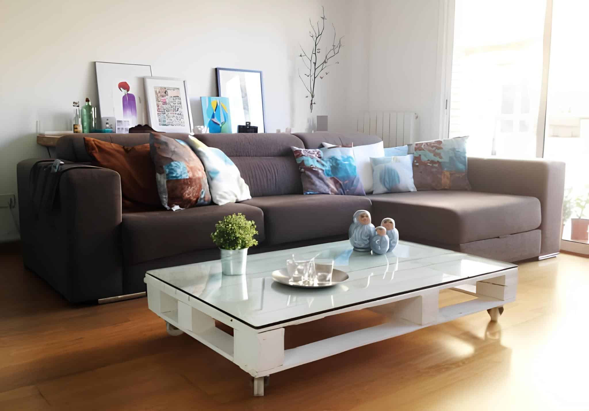 Living room coffee table made from white-painted pallet with glass top