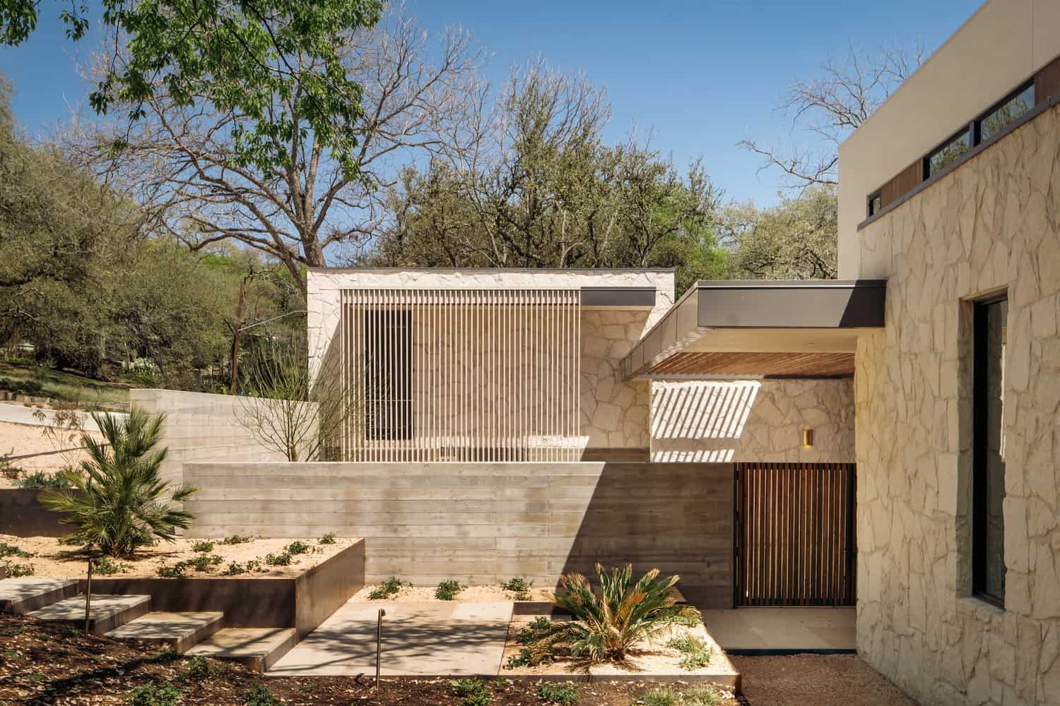 Casa Solis Living Room Fireplace Shelving Casa Solis living room with stone wall, built-in shelving, and modern fireplace.