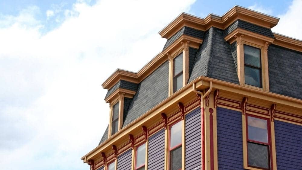 Colorful Mansard Roof House with Decorative Eaves Colorful Victorian house with mansard roof and ornate cornices