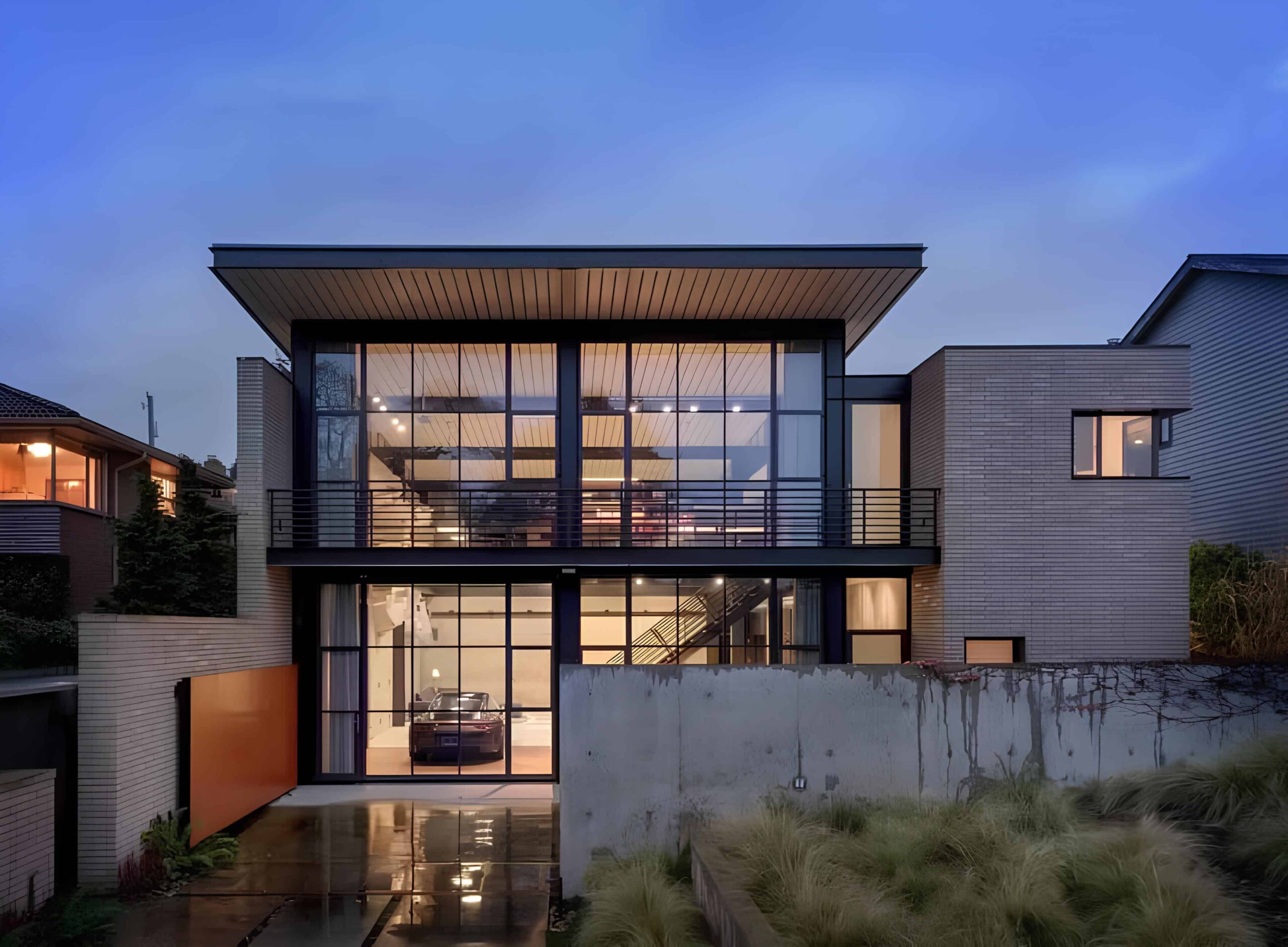 Modern luxury house with extensive glass facades, sleek architectural design, and contemporary details, set against a twilight sky, emphasizing innovative architecture and elegant home design.