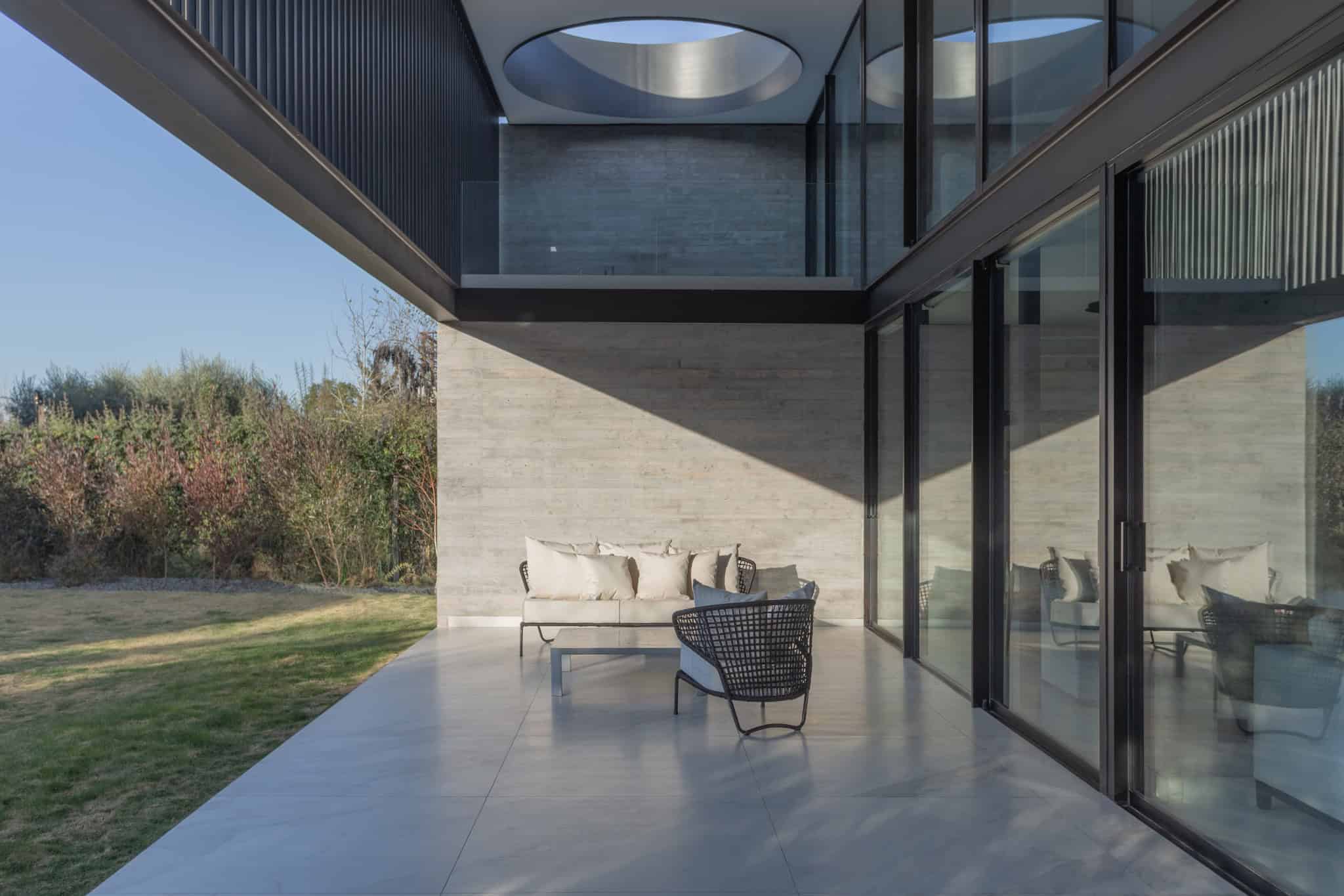 Covered Terrace With Circular Cutout A4Estudio Casa EE by A4estudio - Covered terrace with circular cutout a4estudio