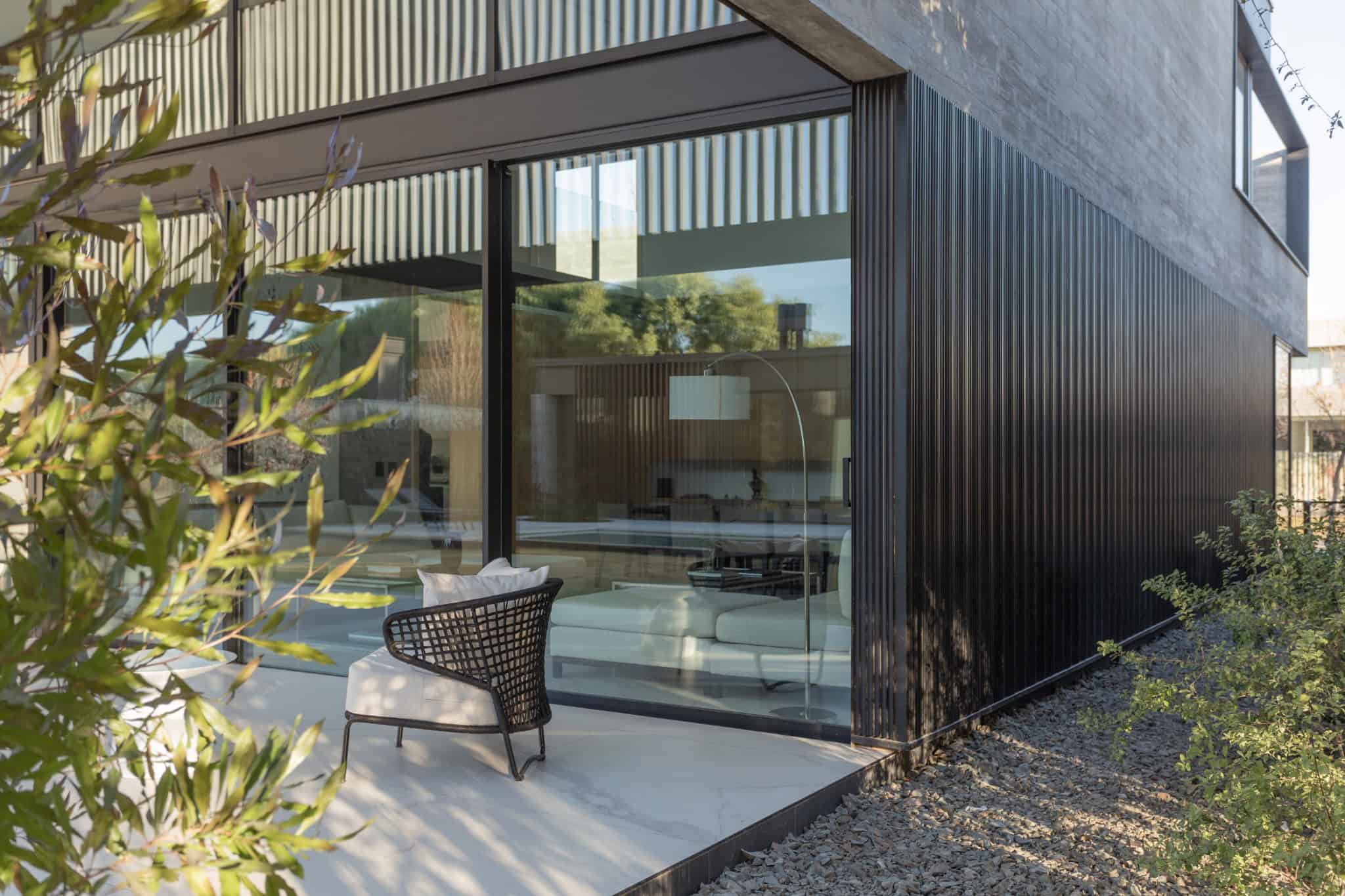 Exterior Corner Chair Glass Wall A4Estudio Casa EE by A4estudio - Exterior corner chair glass wall a4estudio