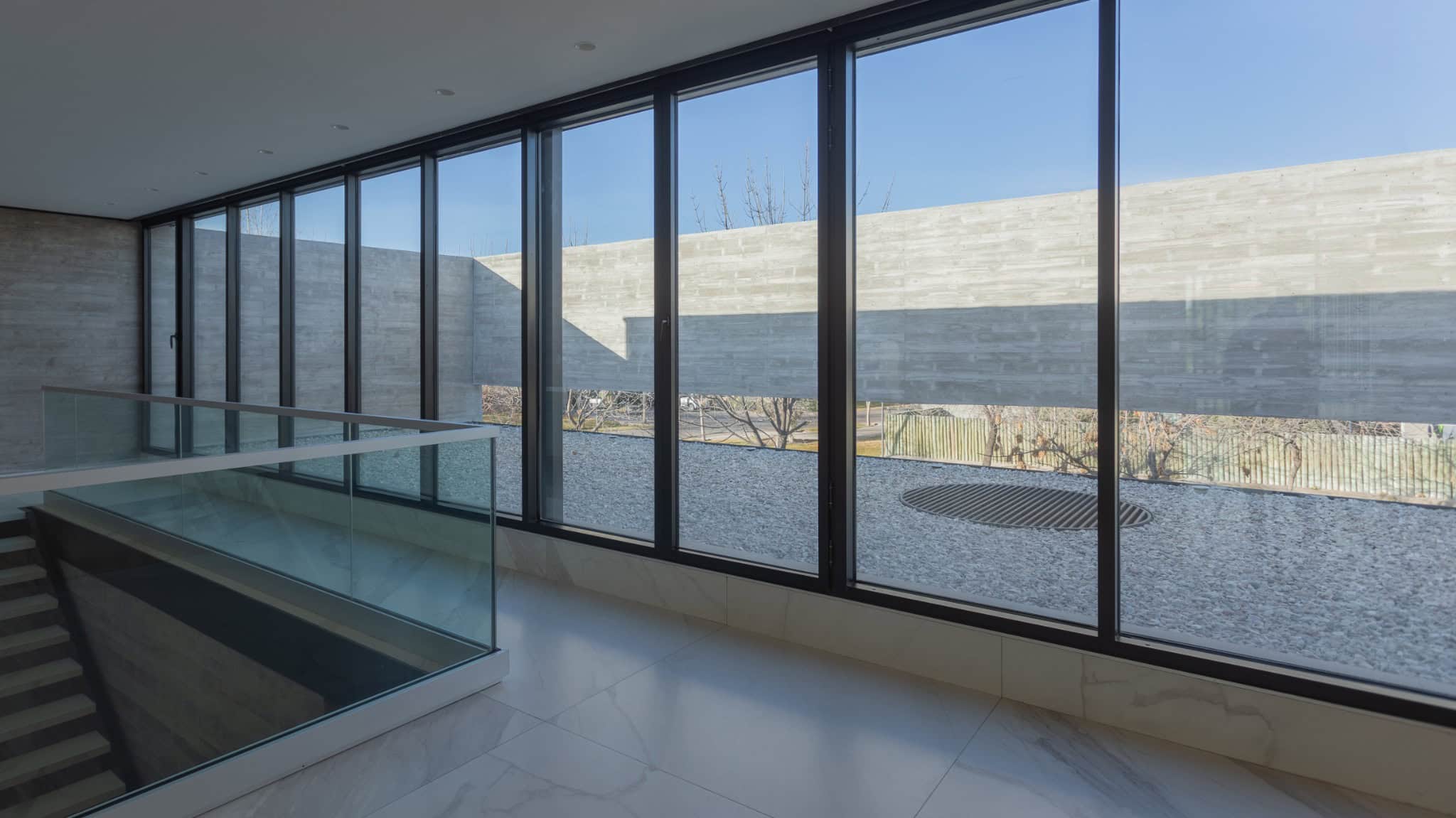 Long Corridor Glass Facade View A4Estudio Casa EE by A4estudio - Long corridor glass facade view a4estudio