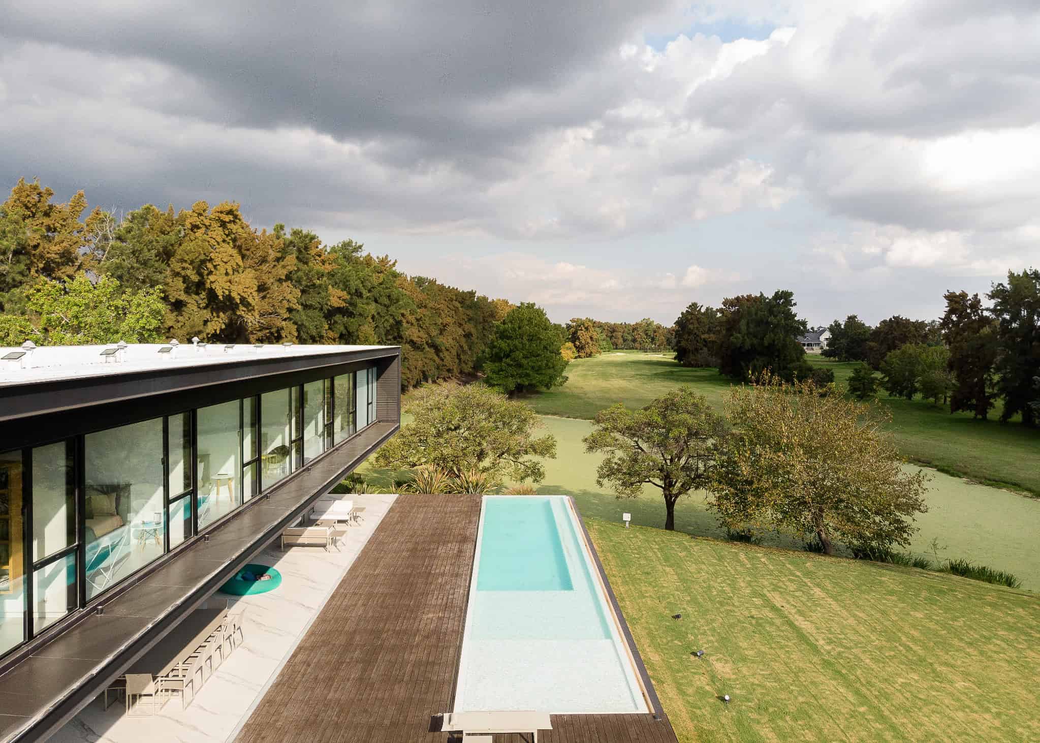 Pacheco House by A4estudio 02 Elegant linear structure of Pacheco House overlooking golf course.