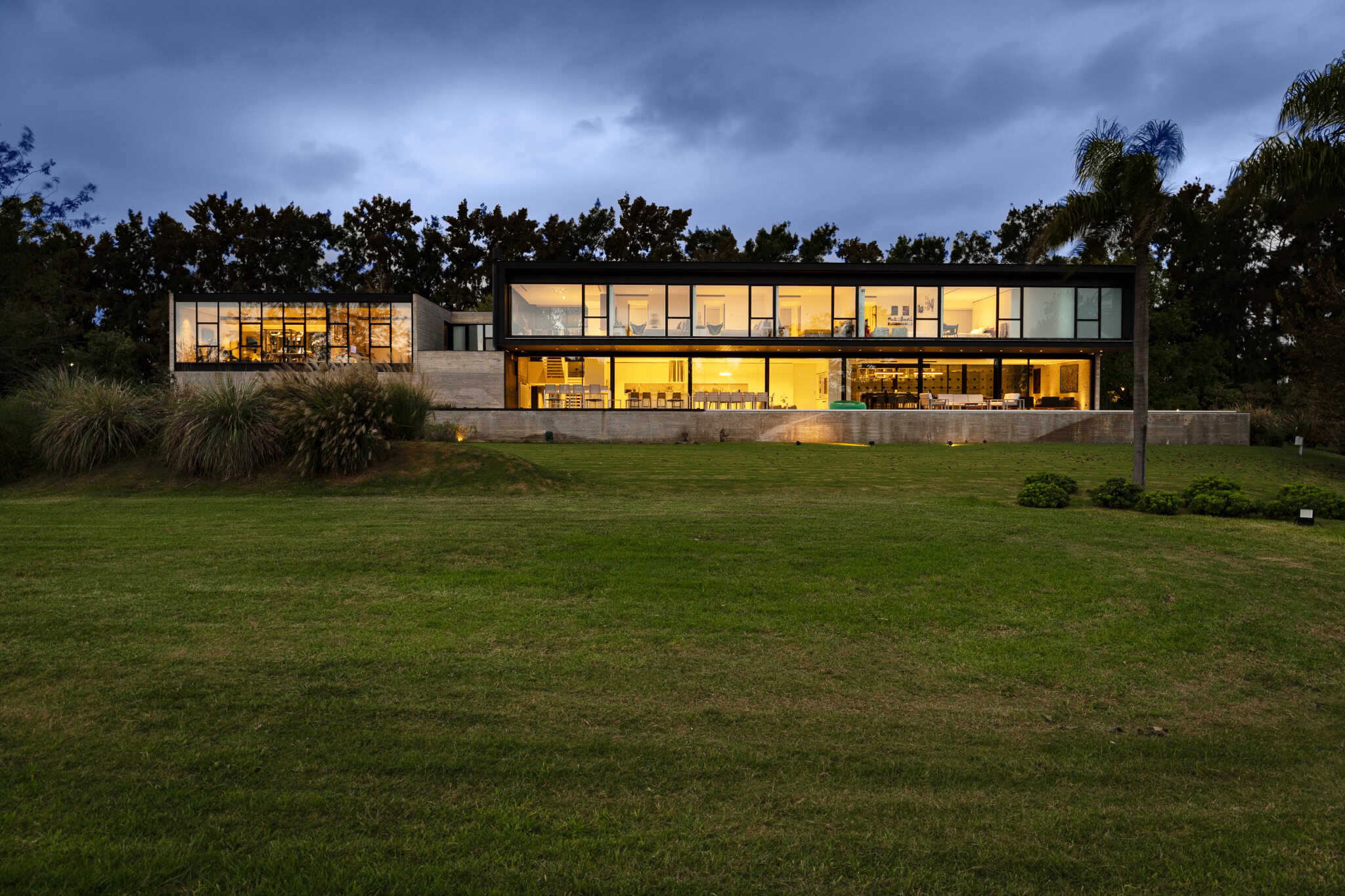 Pacheco House by A4estudio 10 Night view of Pacheco House with illuminated glass façade.