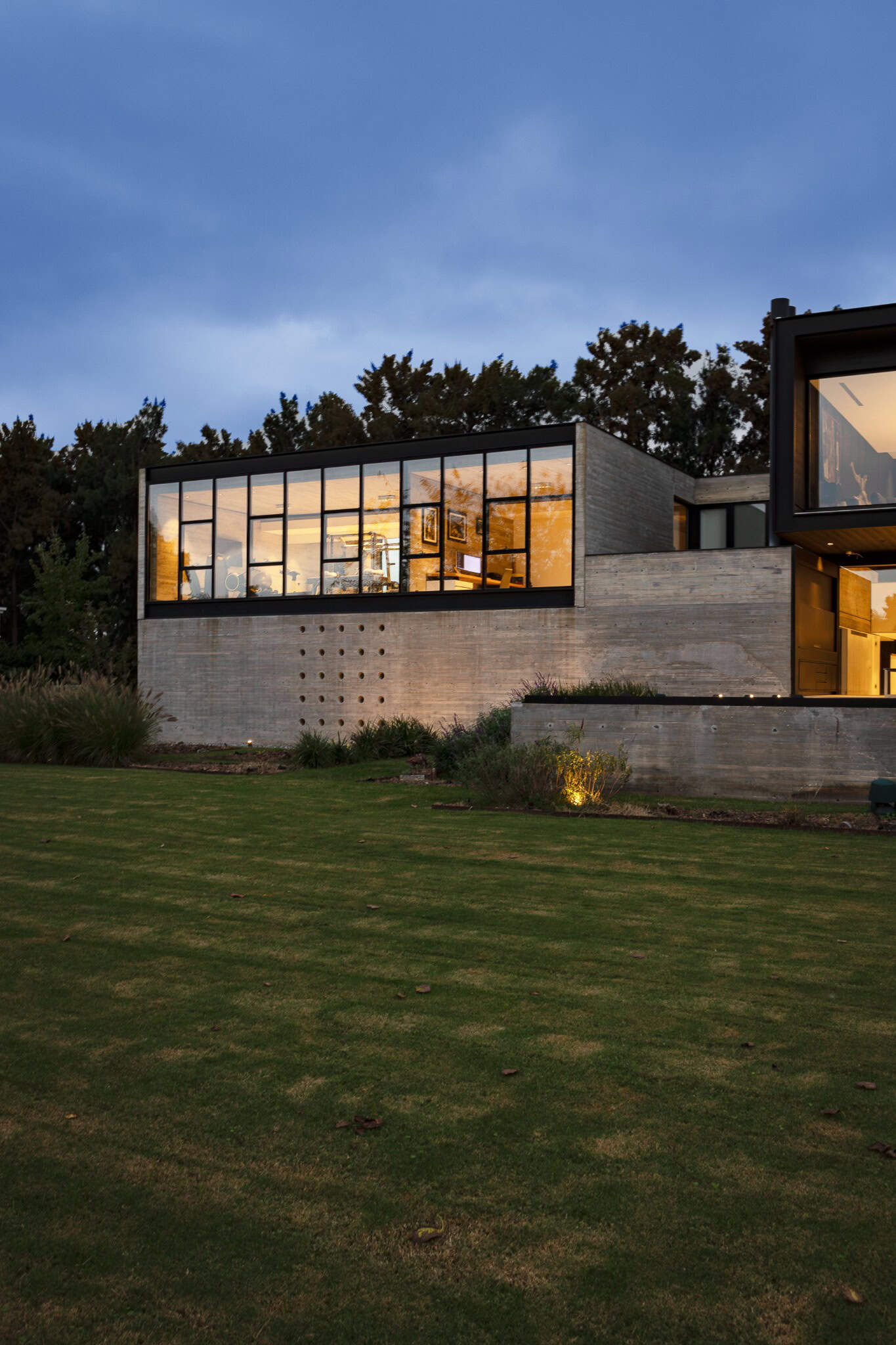 Pacheco House by A4estudio 12 View of Pacheco House’s annex with soft indoor lighting.