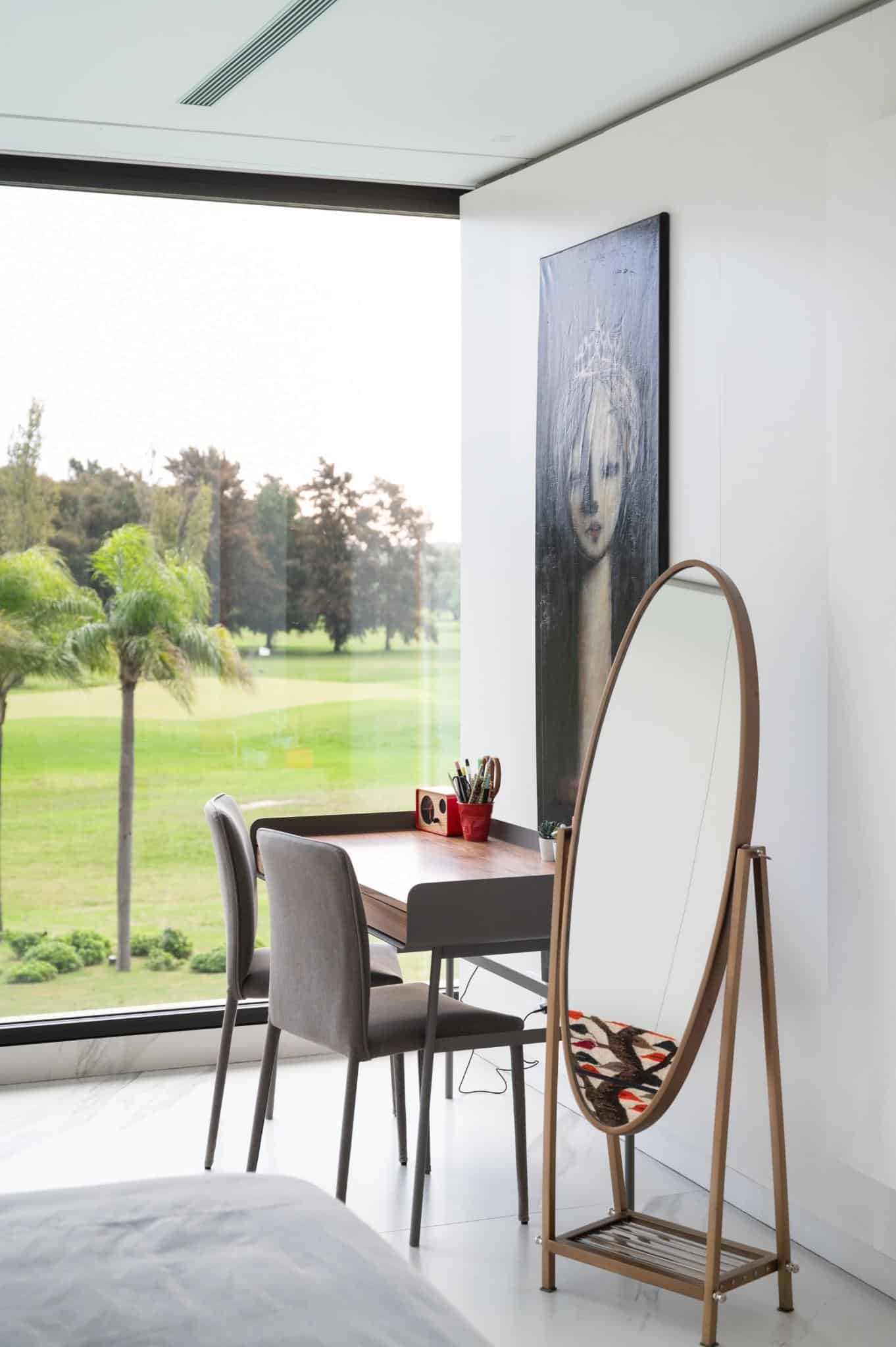 Pacheco House Bedroom Corner Study Corner study space in a bedroom at Pacheco House with a mirror and view of the outdoors.
