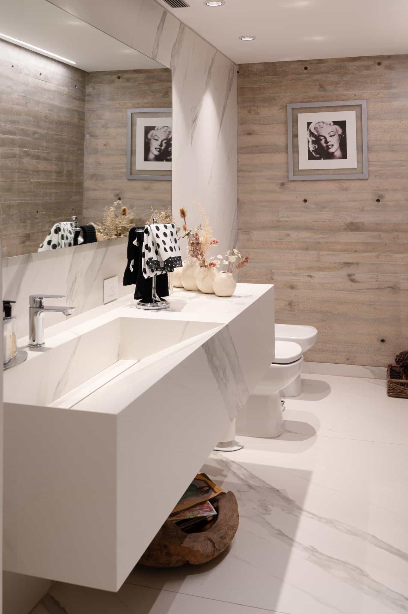 Pacheco House Concrete and Marble Bathroom Bathroom interior in Pacheco House combining concrete wall textures with elegant marble finishes.
