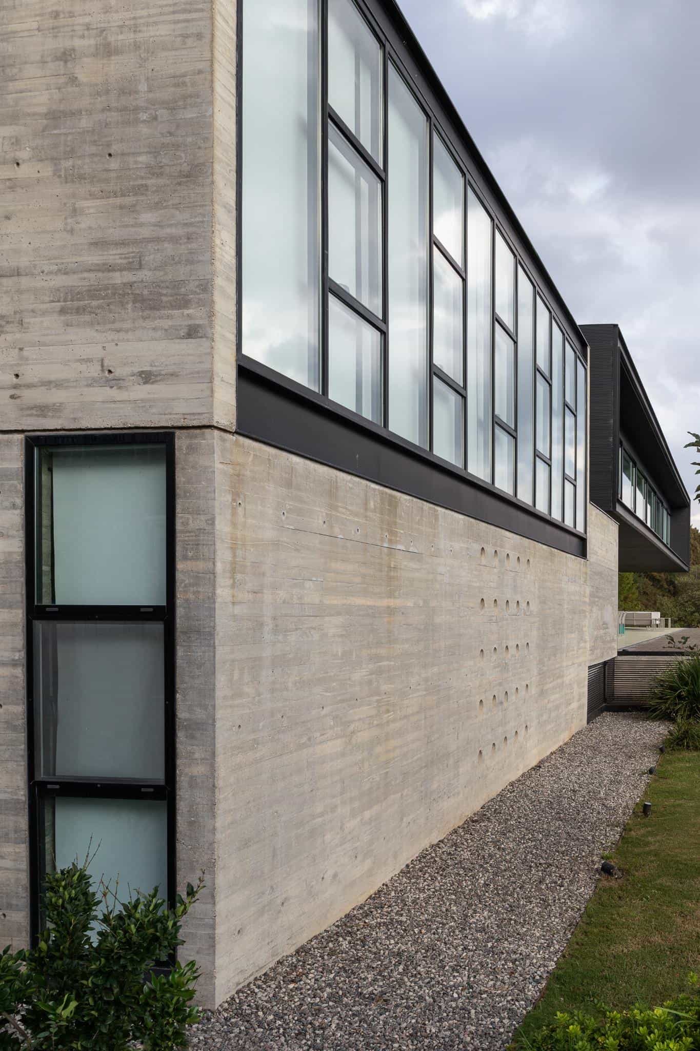 Pacheco House Corner Window Strip Long strip of windows wrapping around the corner of Pacheco House, blending modern transparency and privacy.