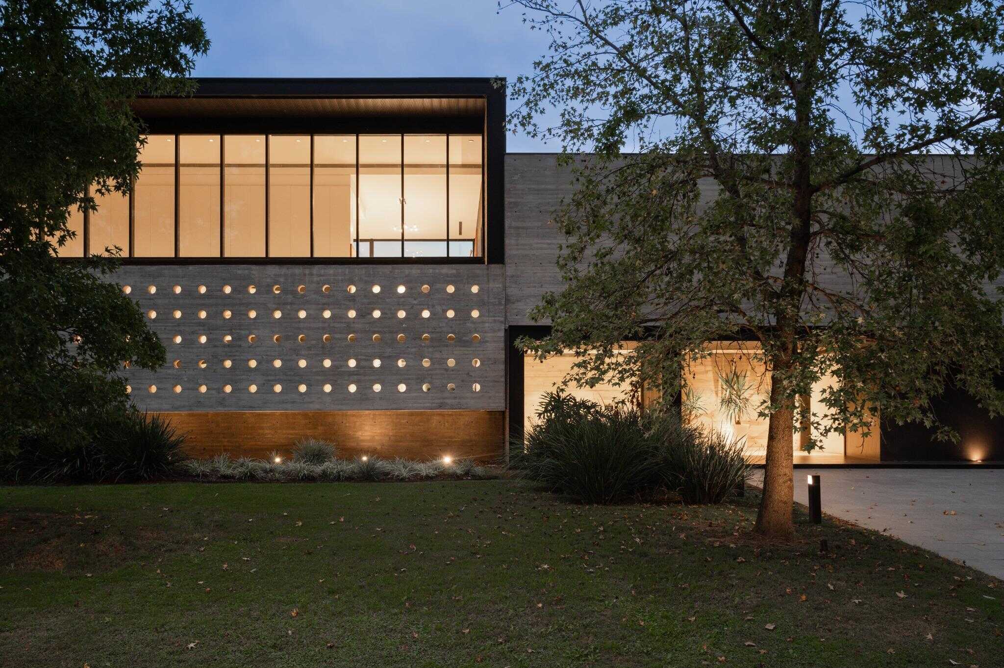 Pacheco House Nighttime Front Elevation Pacheco House elevation view at night, showcasing warm interior light and rhythmic openings.